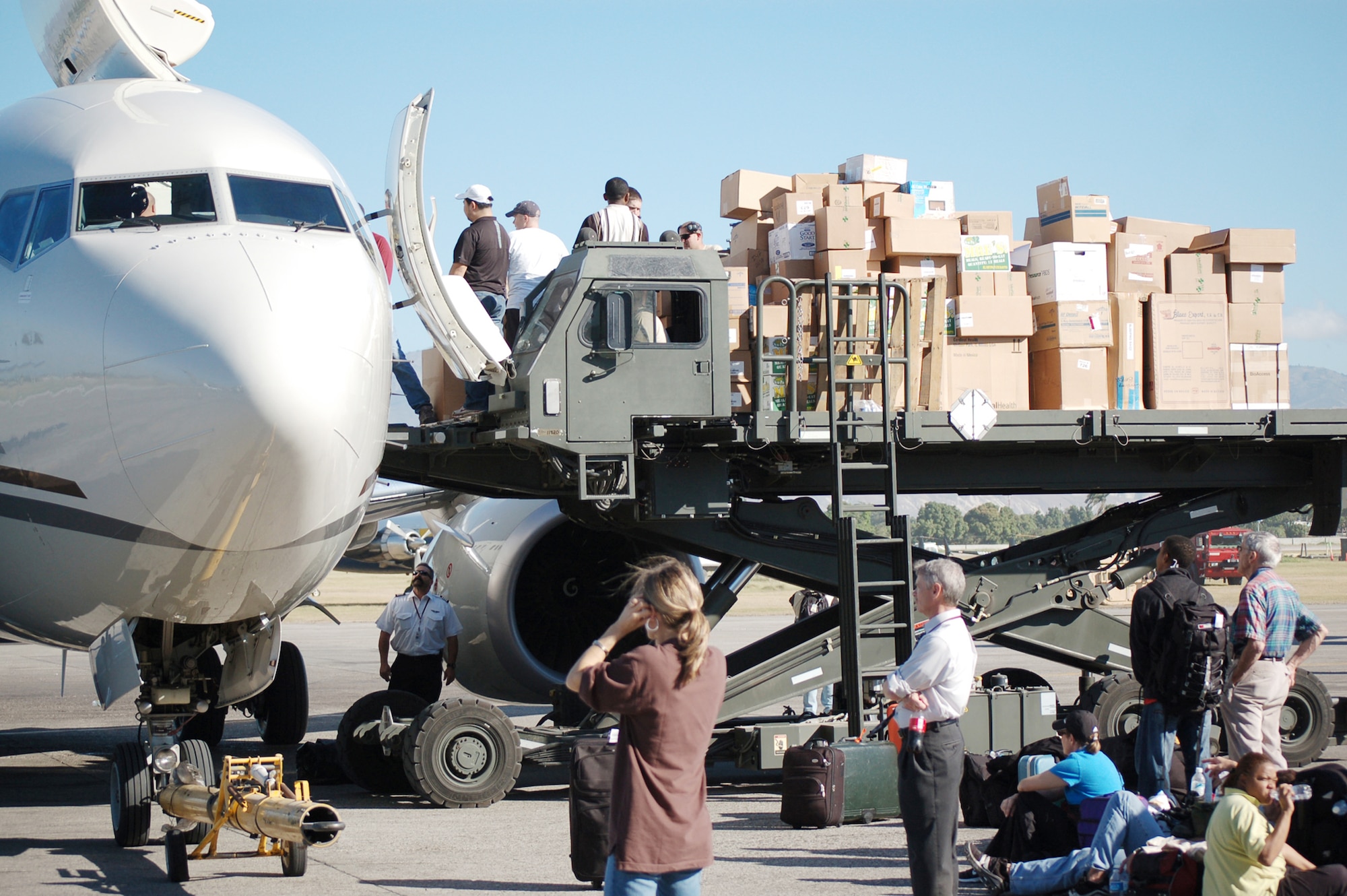 Airmen assigned to the 621st Contingency Response Wing from Joint Base McGuire-Dix-Lakehurst, N.J., assist with the hand-unloading of a civilian relief flight during Operation Unified Response at the Toussaint L'Ouverture International Airport Jan. 21, 2010, in Port-au-Prince, Haiti. The wing responded in the aftermath of a 7.0 magnitude earthquake that crumbled most of the surrounding area killing hundreds of thousands and displacing millions from their homes. (U.S. Air Force photo/Tech. Sgt. Matthew Loy)