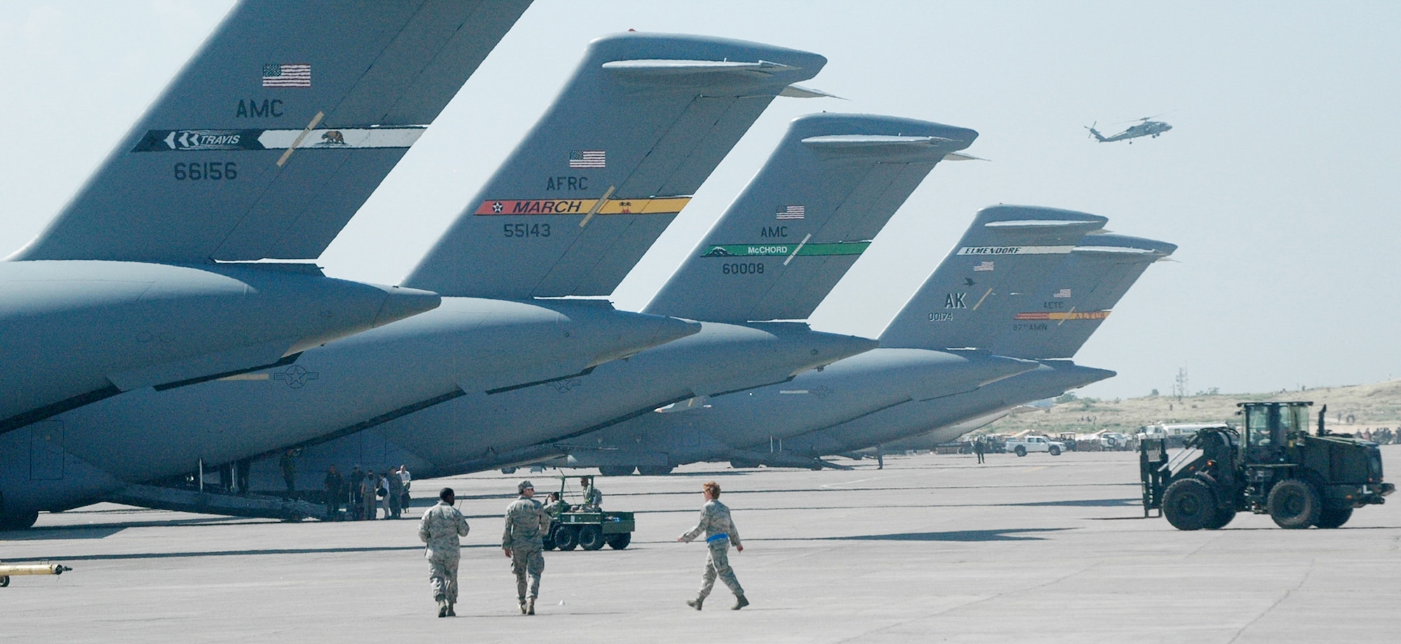 Airmen download C-17 Globemaster IIIs from five different Air Force bases on the ramp at Toussaint L'Ouverture International Airport Jan. 20, 2010, in Port-au-Prince, Haiti. Airmen delivered aid and rescue teams in the aftermath of a 7.0 magnitude earthquake that devastated Haiti. (U.S. Air Force photo/Tech. Sgt. Matthew Loy)