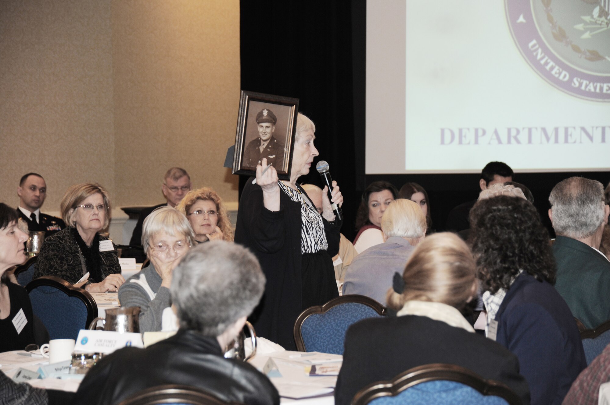A woman shows a photo of her father during a family update meeting sponsored by the Defense Prisoner of War/Missing Personnel Office March 20, 2010, in San Antonio. (U.S. Air Force photo/Staff Sgt. Mareshah Haynes)