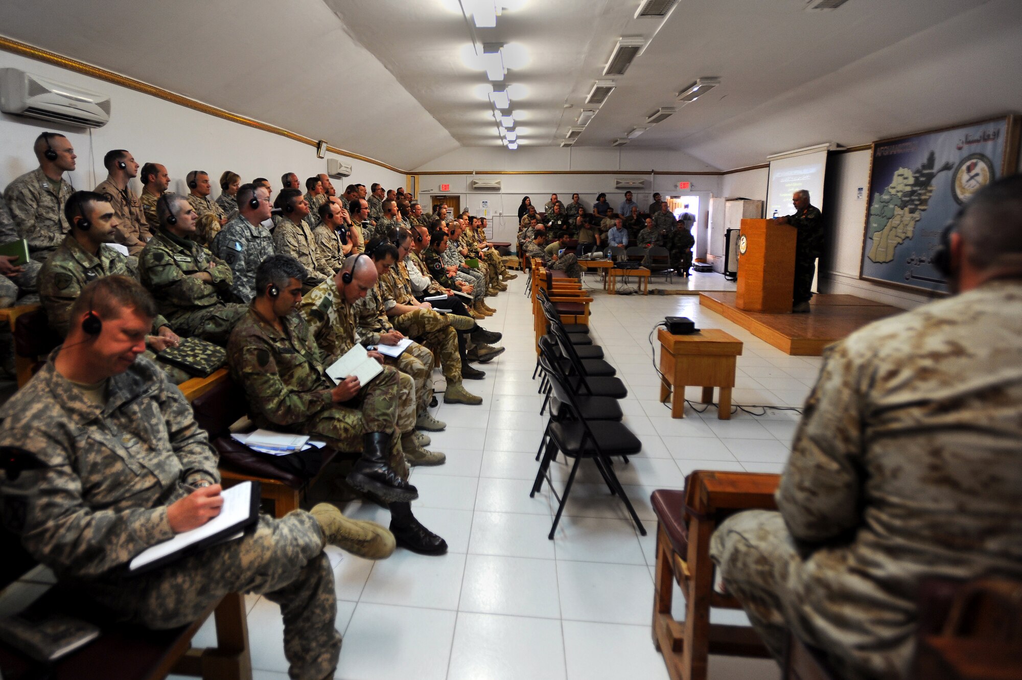 Over ninety senior officers and enlisted military members from ten different countries listen and take notes as Brig. Gen.  Shear Zazai, Afghan National Army 205th Corps commander, speaks at a counterinsurgency (COIN) seminar in Kabul, Afghanistan March 17. The senior officers and non-commissioned officers attended the seminar to gain further knowledge of COIN as Afghan and Coalition troops gear up for combat operations set to take place in Kandahar. (U.S. Air Force photo by Senior Airman Kenny Holston)(Released)
