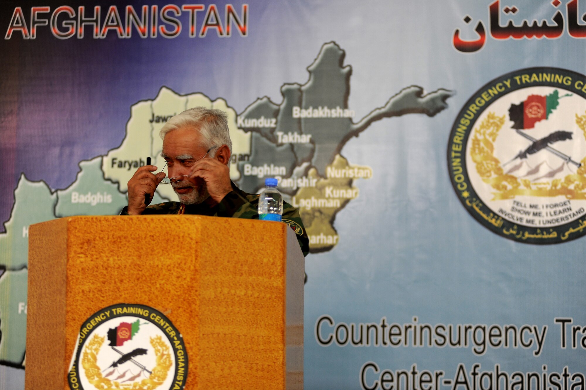 Brigadier Gen.  Shear Zazai, Afghan National Army 205th Corps commander, adjusts his glasses as he prepares to make a speech at a counterinsurgency (COIN) seminar in Kabul, Afghanistan March 17. More than ninety senior officers and enlisted military members from ten different countries attended the seminar to gain further knowledge of COIN as Afghan and Coalition troops gear up for combat operations set to take place in Kandahar. (U.S. Air Force photo by Senior Airman Kenny Holston)(Released)
