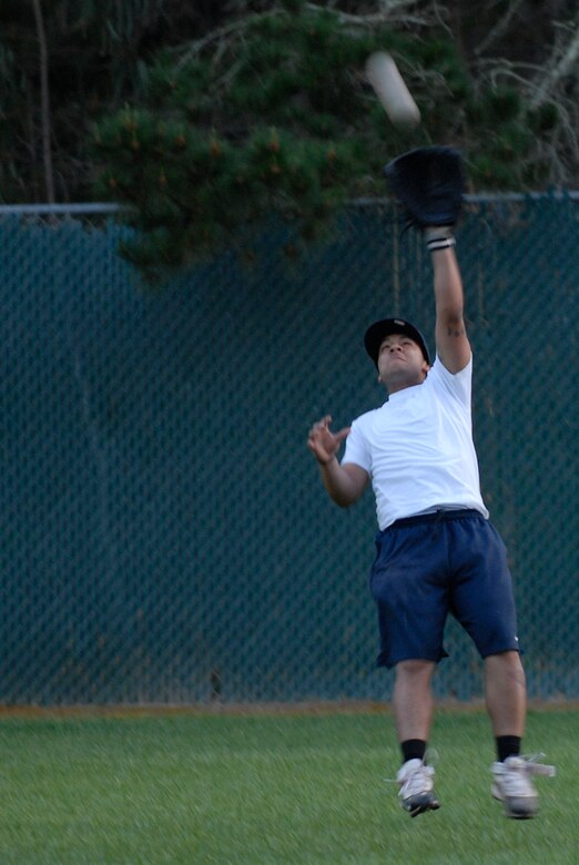 VANDENBERG AIR FORCE BASE, Calif. --   Leaping to make the catch, Joel Rivera, a 381st Training Group intramural softball team member, raises his glove for the out during the base intramural softball championship Friday, March 19, 2010, behind the old fitness center here.  The Army Prison Guard intramural softball team played a doubleheader against the 381st Training Group, winning 12-9 and taking the championship game 12-2.  (U.S. Air Force photo/Senior Airman Andrew Satran) 

 

 

 