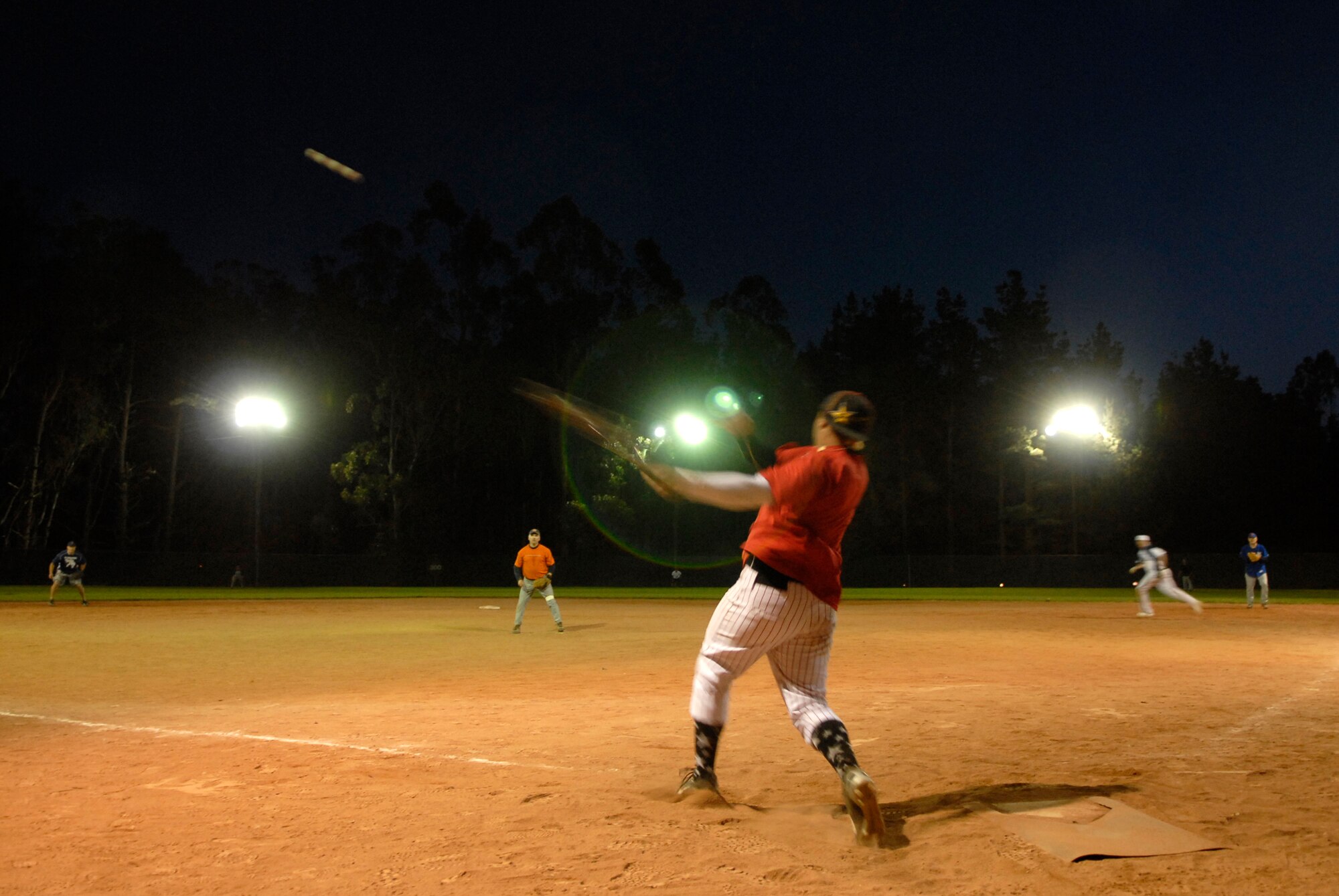 VANDENBERG AIR FORCE BASE, Calif. -- Johnathon Terrones, an Army Prison Guard team member,  hits a home run during the base intramural softball championship Friday, March 19, 2010, in the field behind the old fitness center here.  The Army Prison Guard intramural softball team played a doubleheader against the 381st Training Group team, winning 12-9 and taking the championship game 12-2.  (U.S. Air Force photo/Senior Airman Andrew Satran) 

 
 

 

 

 

 

 