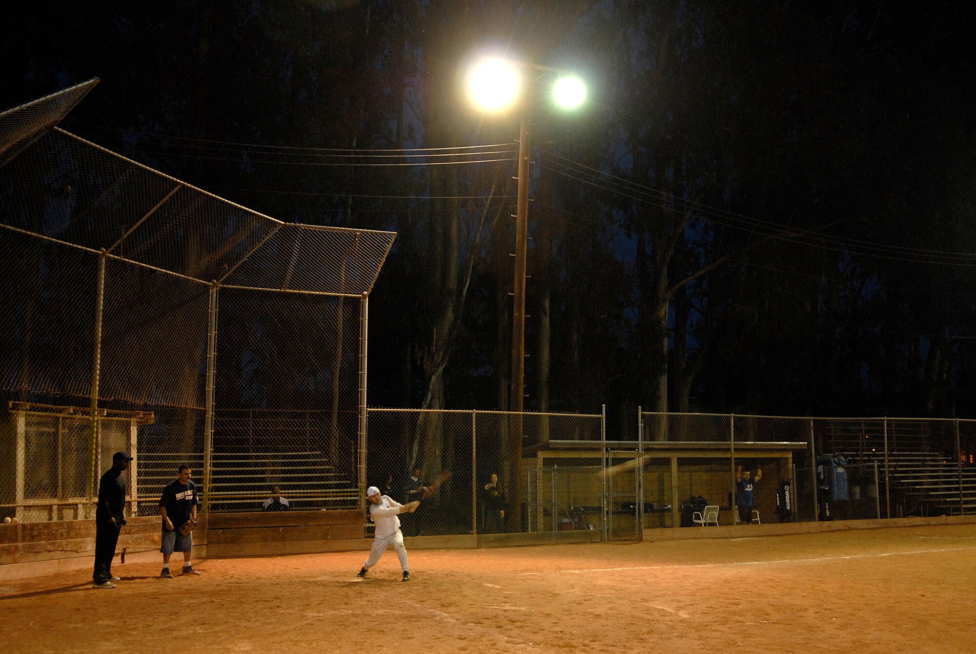 VANDENBERG AIR FORCE BASE, Calif. --Mike Hinkle, a 381st Training Group intramural softball team member, knocks a ball into the outfield during the base intramural softball championship Friday, March 19, 2010, in the field behind the old fitness center here.  The Army Prison Guard intramural softball team played a doubleheader against the 381st Training Group team, winning 12-9 and taking the championship game 12-2.  (U.S. Air Force photo/Senior Airman Andrew Satran) 

 

 

 

 

 

 