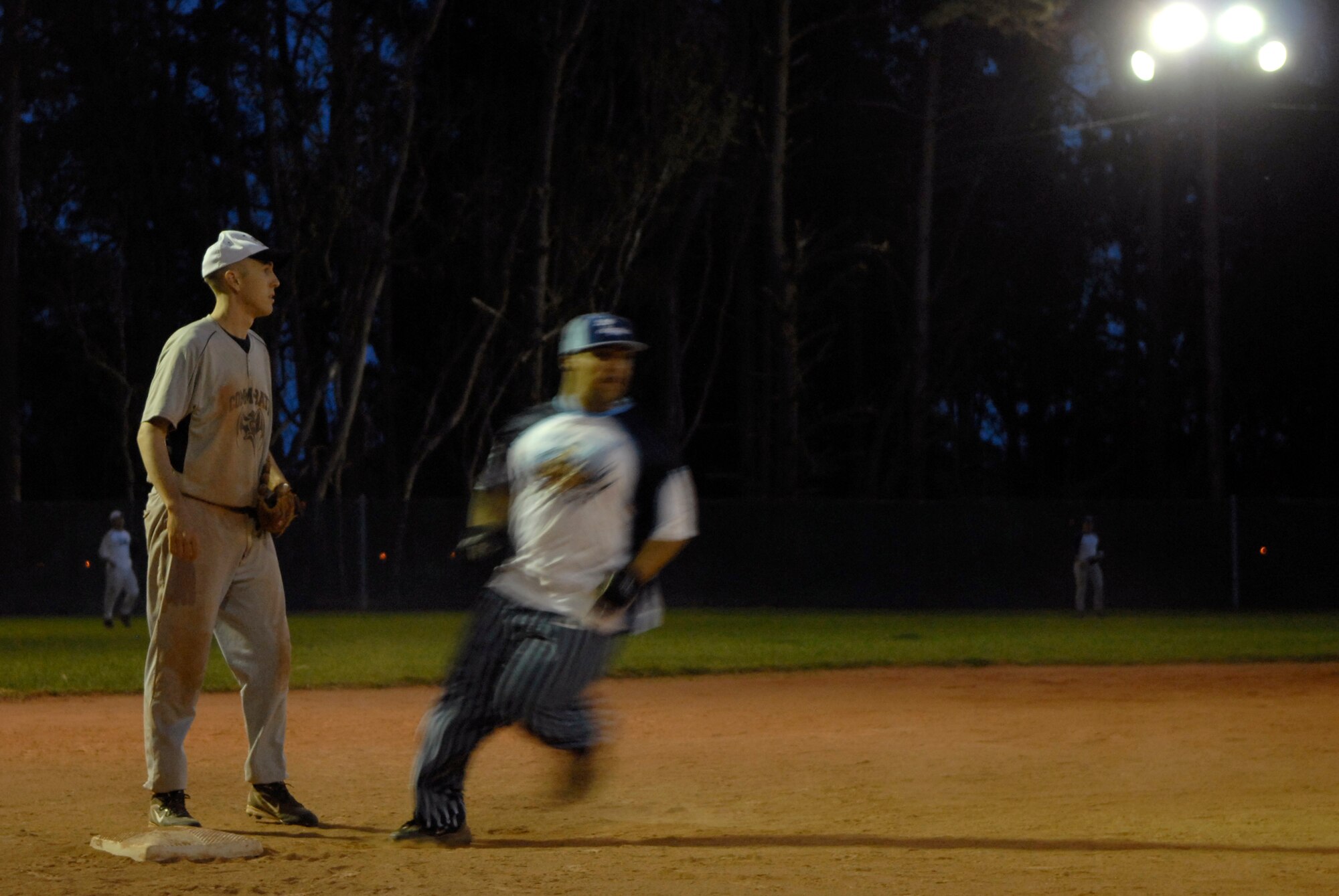 VANDENBERG AIR FORCE BASE, Calif. -- Rushing to third base, Efrain Roldan, an Army Prison Guard team member, avoids third baseman Michael Thomas, a 381st Training Group team member, during the base intramural softball championship Friday, March 19, 2010, in the field behind the old fitness center here.  The Army Prison Guard intramural softball team played a doubleheader against the 381st Training Group team, winning 12-9 and taking the championship game 12-2.  (U.S. Air Force photo/Senior Airman Andrew Satran) 

 

 

 

 

 