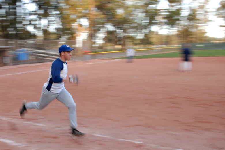 VANDENBERG AIR FORCE BASE, Calif. -- Ben Drake, a 381st Training Group intramural softball team member, dashes to first during the base intramural softball championship Friday, March 19, 2010, in the field behind the old gym here.  The Army Prison Guard intramural softball team played a doubleheader against the 381st Training Group team, winning 12-9 and taking the championship game 12-2.  (U.S. Air Force photo/Senior Airman Andrew Satran) 

 

 