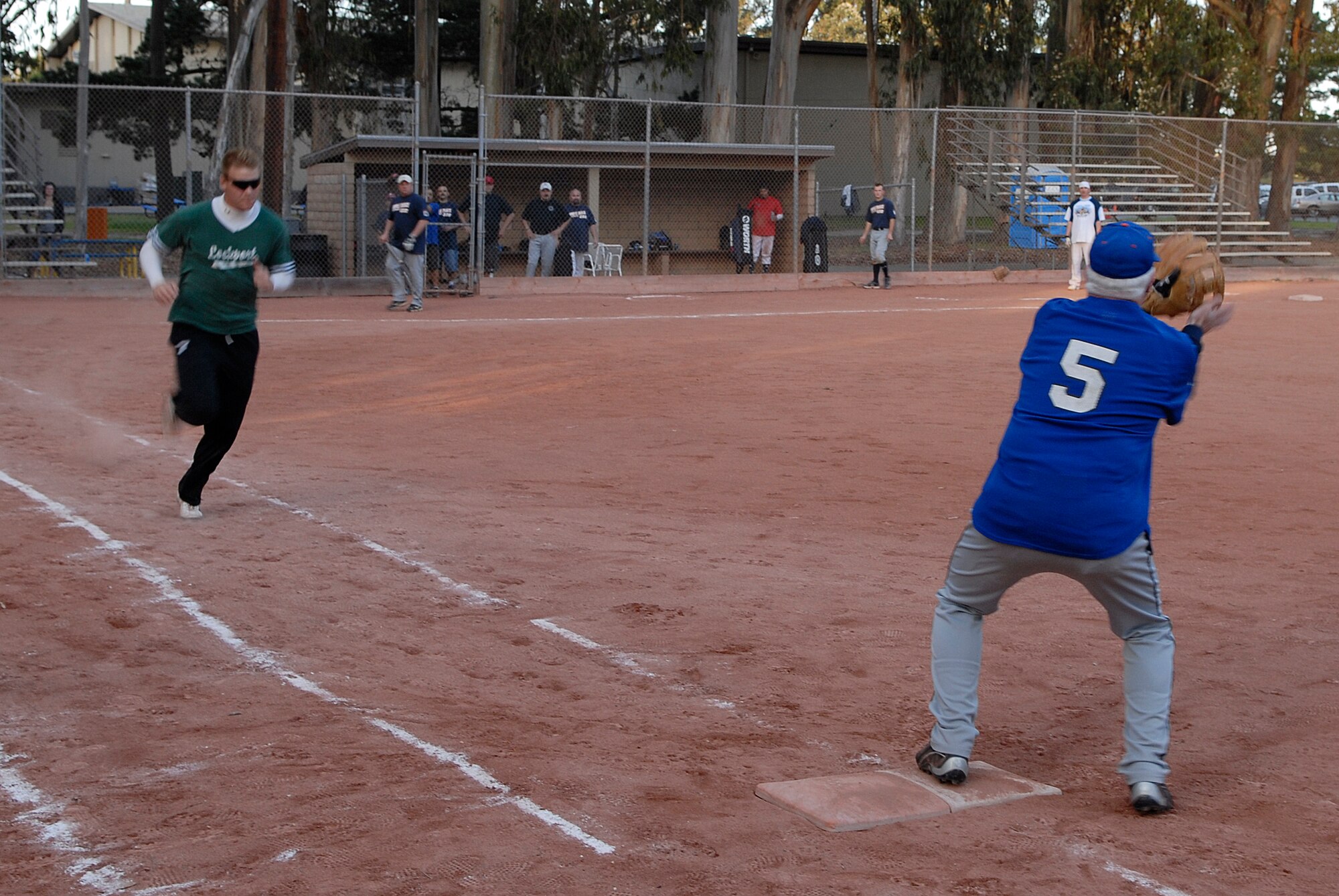 VANDENBERG AIR FORCE BASE, Calif. -- Sprinting to first base, Mike Kearns, an Army Prison Guard team member, charges after hitting a line drive during the base intramural softball championship Friday, March 19, 2010, in the field behind the old fitness center here.  The Army Prison Guard intramural softball team played a doubleheader against the 381st Training Group team, winning 12-9 and taking the championship game 12-2.  (U.S. Air Force photo/Senior Airman Andrew Satran) 

 