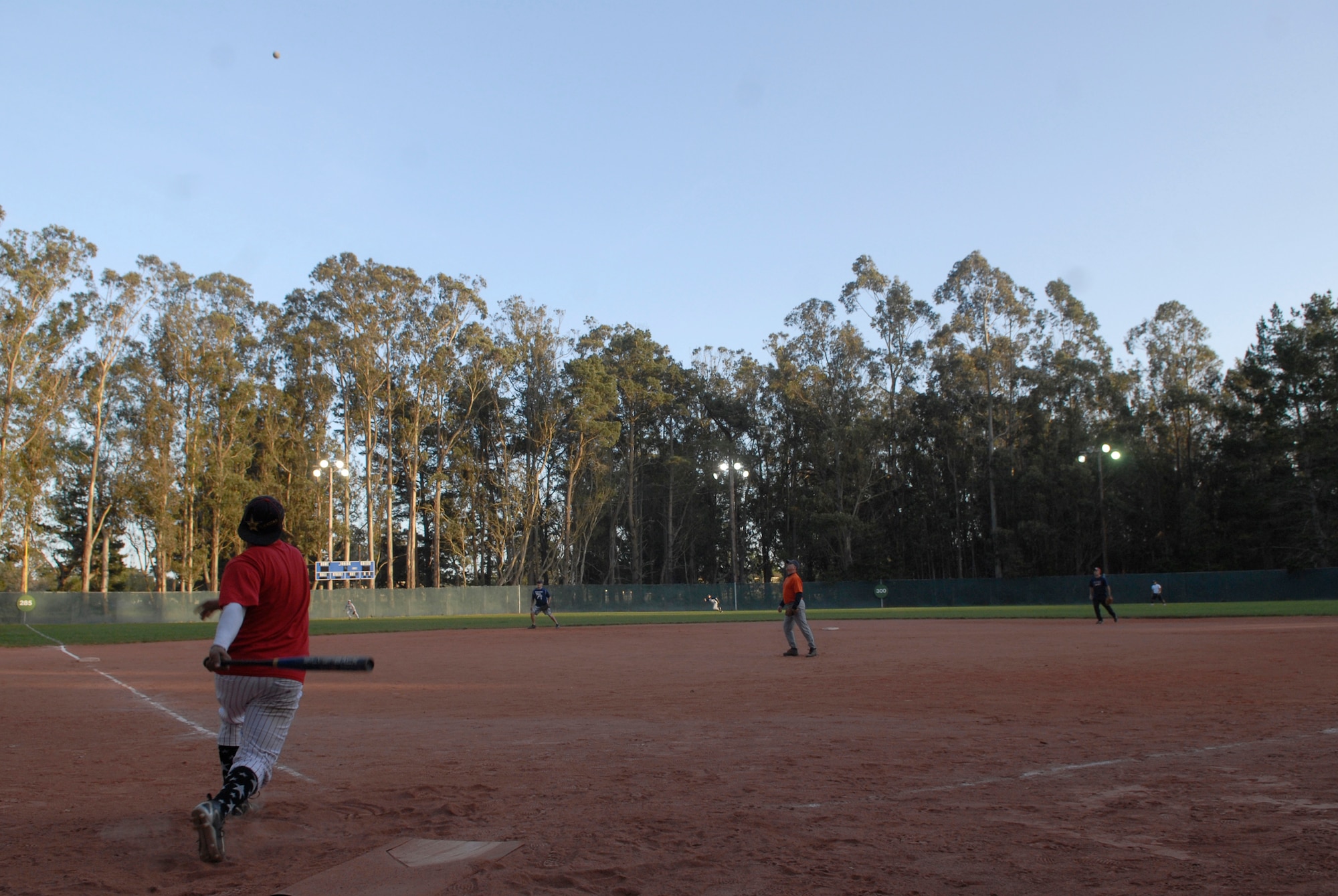 VANDENBERG AIR FORCE BASE, Calif. -- Johnathon Terrones, an Army Prison Guard team member,  knocks a ball into the outfield during the base intramural softball championship Friday, March 19, 2010, in the field behind the old fitness center here.  The Army Prison Guard intramural softball team played a doubleheader against the 381st Training Group team, winning 12-9 and taking the championship game 12-2.  (U.S. Air Force photo/Senior Airman Andrew Satran) 

 