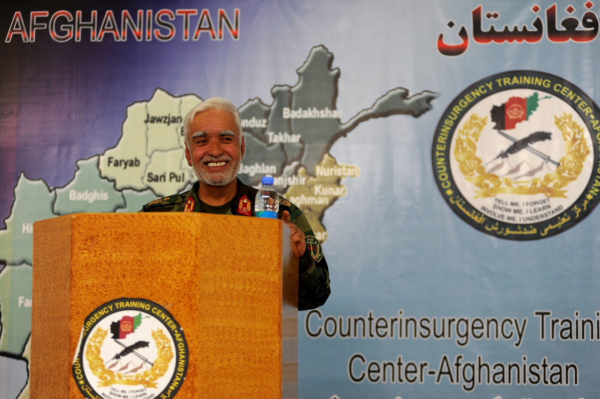 Brig. Gen.  Shear Zazai, Afghan National Army 205th Corps commander, smiles after making a joke during his speech at a counterinsurgency (COIN) seminar in Kabul, Afghanistan March 17. Over ninety senior officers and enlisted military members from ten different countries attended the seminar to gain further knowledge of COIN as Afghan and Coalition troops gear up for phase three of combat operations set to take place in Kandahar. (U.S. Air Force photo by Senior Airman Kenny Holston)(Released)
