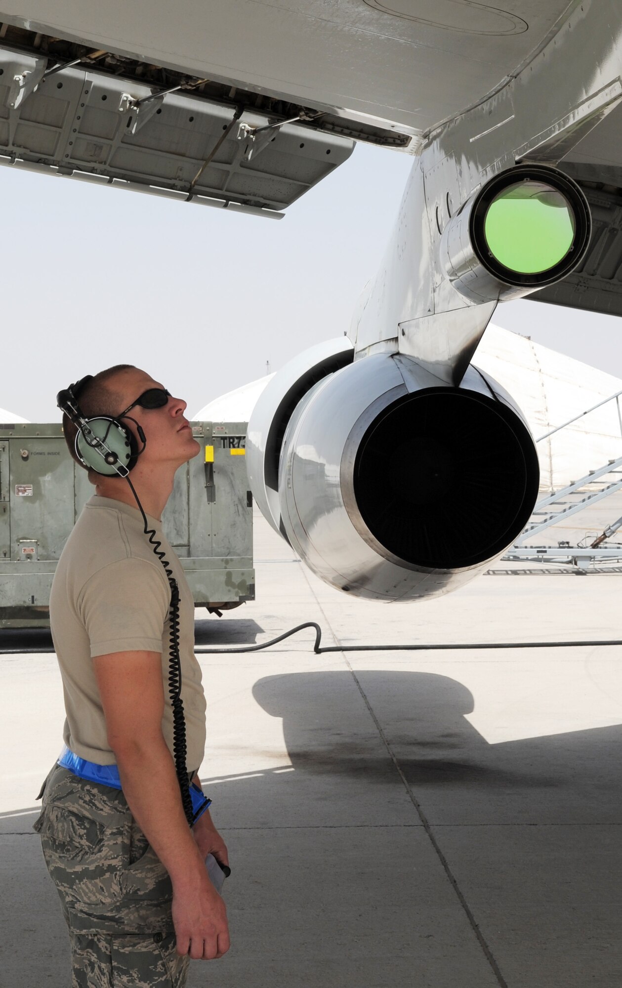 Senior Airman Joshua Kneese, E-3 Sentry crew chief with the 380th Expeditionary Aircraft Maintenance Squadron Sentry aircraft maintenance unit, removes a tow bar from a "tug" while moving an E-3 into a parking space on the flightline during operations on the flightline for the 380th Air Expeditionary Wing at a non-disclosed base in Southwest Asia on March 23, 2010.  Airman Kneese is deployed from the 552nd Aircraft Maintenance Squadron at Tinker Air Force Base, Okla., and his hometown is Reno, Nev. (U.S. Air Force Photo/Master Sgt. Scott T. Sturkol/Released)