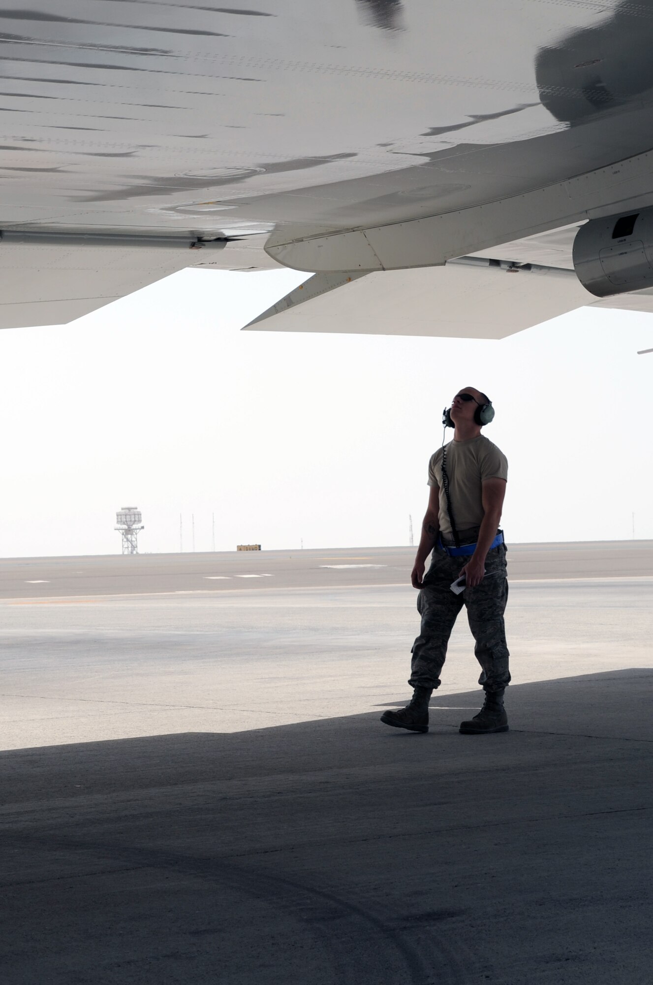 Senior Airman Joshua Kneese, E-3 Sentry crew chief with the 380th Expeditionary Aircraft Maintenance Squadron Sentry aircraft maintenance unit, looks over the wings of an E-3 during operations on the flightline for the 380th Air Expeditionary Wing at a non-disclosed base in Southwest Asia on March 23, 2010.  Airman Kneese is deployed from the 552nd Aircraft Maintenance Squadron at Tinker Air Force Base, Okla., and his hometown is Reno, Nev. (U.S. Air Force Photo/Master Sgt. Scott T. Sturkol/Released)