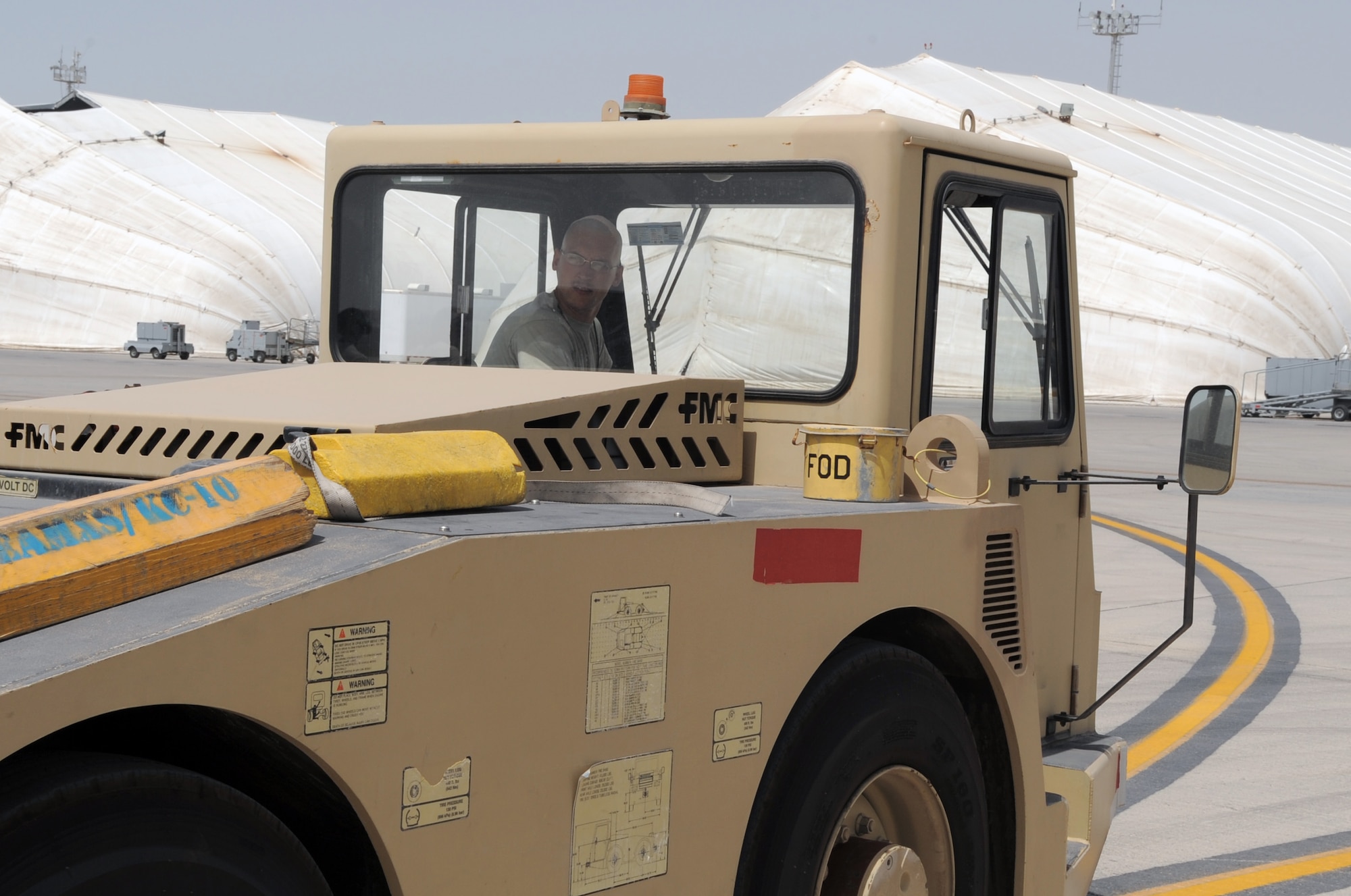 Senior Airman John Mason, E-3 Sentry crew chief with the 380th Expeditionary Aircraft Maintenance Squadron Sentry aircraft maintenance unit, drives a "tug" while moving an E-3 into a parking space on the flightline during operations on the flightline for the 380th Air Expeditionary Wing at a non-disclosed base in Southwest Asia on March 23, 2010.  Airman Mason is deployed from the 552nd Aircraft Maintenance Squadron at Tinker Air Force Base, Okla., and his hometown is Lexington, Ky. (U.S. Air Force Photo/Master Sgt. Scott T. Sturkol/Released)