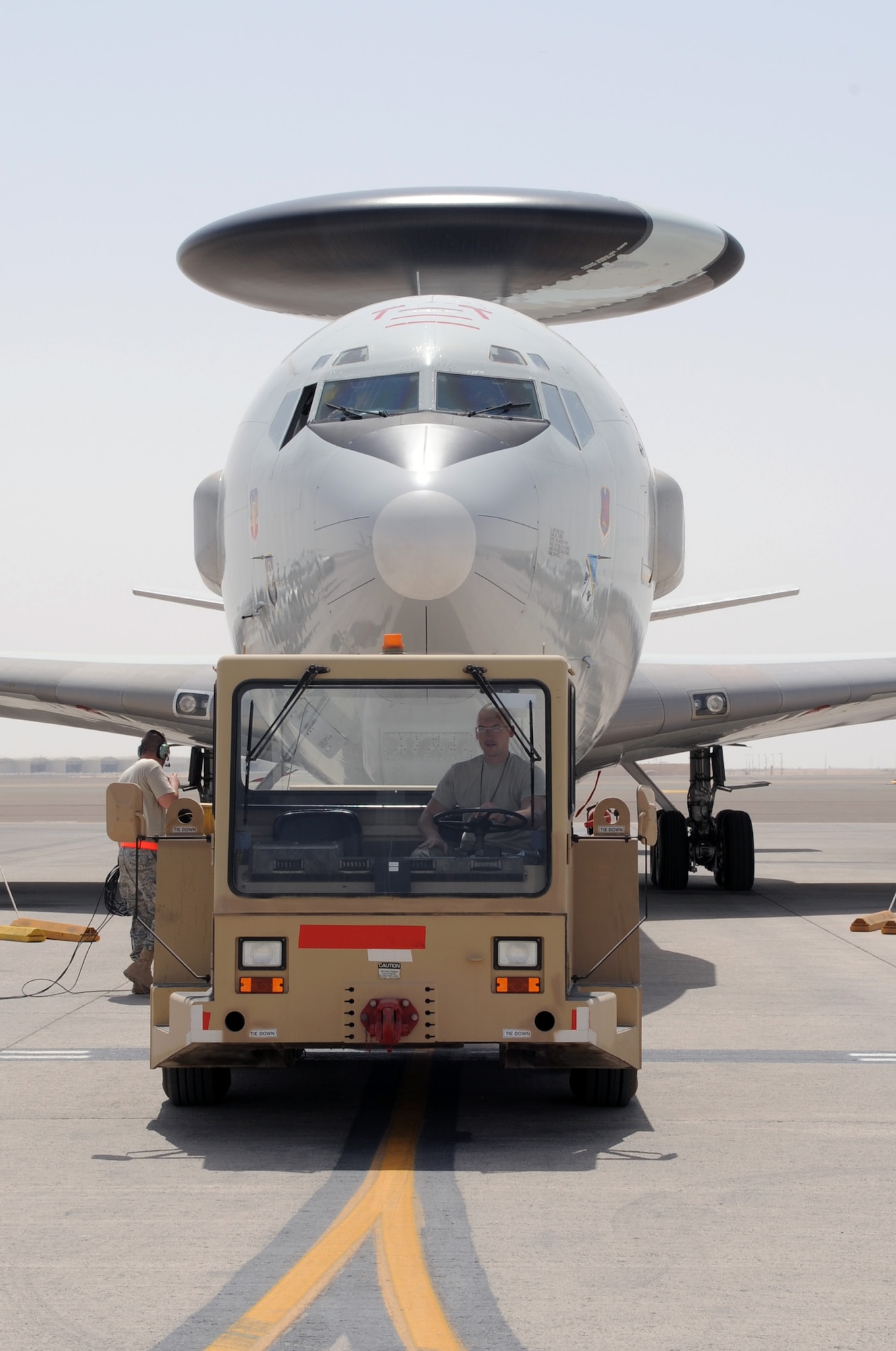 Airmen assigned to the 380th Expeditionary Aircraft Maintenance Squadron's Sentry aircraft maintenance unit move an E-3 Sentry Airborne Warning and Control System, or AWACS, aircraft into a parking space on the flightline of a non-disclosed base in Southwest Asia on March 23, 2010. The action comes 33 years to the day when the Air Force received its first E-3 Sentry into its inventory on March 23, 1977. This E-3, assigned to the 965th Expeditionary Airborne Air Control Squadron, along with the maintenance Airmen are deployed to Southwest Asia from the 552nd Air Control Wing at Tinker Air Force Base, Okla. (U.S. Air Force Photo/Master Sgt. Scott T. Sturkol/Released)