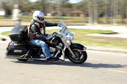 A member of Joint Base Charleston takes off from the base theater after attending an annual mandatory motorcycle riding briefing, which kicked off Air Mobility Command?s Spring Safety Focus March 19, 2010. More than 200 motorcycle riders from Joint Base Charleston showed up for the mandatory briefing and had the opportunity to participate in a Motorcycle Mentoring ride to Naval Weapons Station Short Stay. (U.S. Air Force photo/Staff Sgt. Marie Brown)
