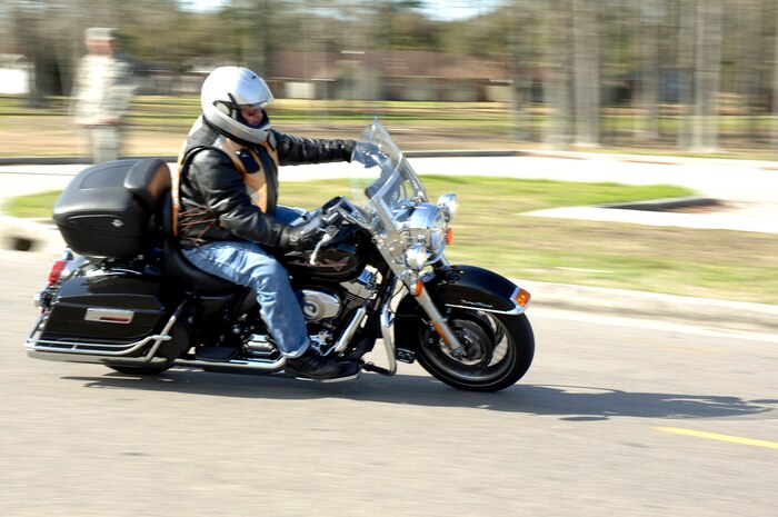 A member of Joint Base Charleston takes off from the base theater after attending an annual mandatory motorcycle riding briefing, which kicked off Air Mobility Command?s Spring Safety Focus March 19, 2010. More than 200 motorcycle riders from Joint Base Charleston showed up for the mandatory briefing and had the opportunity to participate in a Motorcycle Mentoring ride to Naval Weapons Station Short Stay. (U.S. Air Force photo/Staff Sgt. Marie Brown)