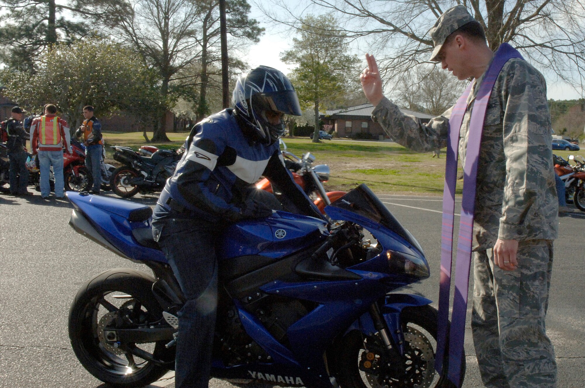 U.S. Air Force Chaplain (Capt.) Scott Bowen blesses a member of Joint Base Charleston as part of the blessing of the bikes routine after the conclusion of an annual mandatory motorcycle riding briefing, which kicked off Air Mobility Command?s Spring Safety Focus March 19, 2010. More than 200 motorcycle riders from Joint Base Charleston showed up for the mandatory briefing and had the opportunity to participate in a Motorcycle Mentoring ride to Naval Weapons Station Short Stay. Chaplain Bowen is with the 628th Air Base Wing chapel. (U.S. Air Force photo/Staff Sgt. Marie Brown)
