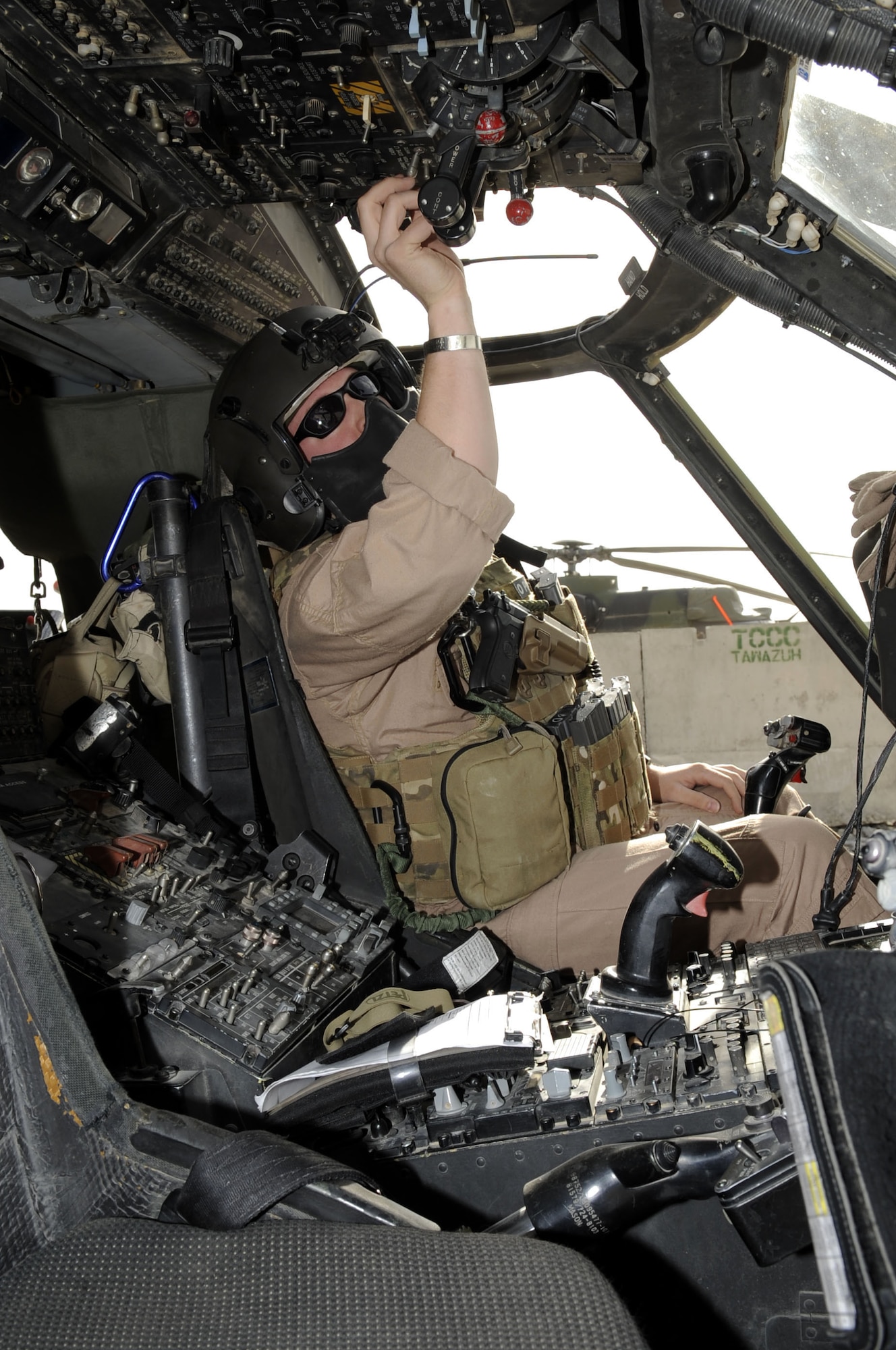 Capt. Rob Roth, 66th Expeditionary Rescue Squadron mission pilot, conducts preflight checks inside of a HH-60G Pave Hawk helicopter here March 5.  Captain Roth is assigned to the 66th Rescue Squadron from Nellis AFB, NV.  (U.S. Air Force photo by Senior Airman Nancy Hooks/Released)