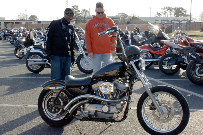 U.S. Air Force Chief Master Sgt. Mike Ivey, right, and U.S. Navy Master Chief Petty Officer Mike Jackson, left, take a close look at a motorcycle during an annual mandatory meeting for all Joint Base Charleston motorcycle riders, which kicked off Air Mobility Command?s Spring Safety Focus March 19, 2010 at the base theater. A competition was held which announced the first and second place winners which showcased the best bikes out of 134 which included cruisers and sports bikes. Chief Ivey is the 628th Air Base Wing command chief and Chief Jackson is the Naval Weapons Station Charleston command master chief. (U.S. Air Force photo/Staff Sgt. Marie Brown)
