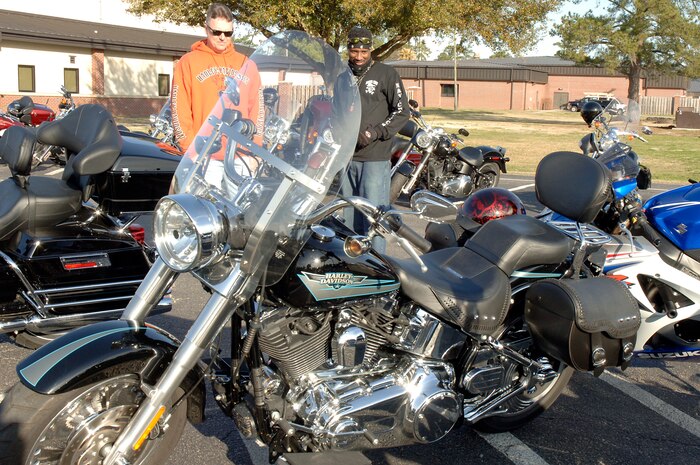 U.S. Air Force Chief Master Sgt. Mike Ivey, left, and U.S. Navy Master Chief Petty Officer Mike Jackson, right, take a close look at a motorcycle during an annual mandatory meeting for all Joint Base Charleston motorcycle riders, which kicked off Air Mobility Command?s Spring Safety Focus March 19, 2010 at the base theater. A competition was held which announced the first and second place winners which showcased the best bikes out of 134 which included cruisers and sports bikes. Chief Ivey is the 628th Air Base Wing command chief and Chief Jackson is the Naval Weapons Station Charleston command master chief. (U.S. Air Force photo/Staff Sgt. Marie Brown)