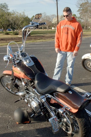 U.S. Air Force Chief Master Sgt. Mike Ivey takes a close look at a motorcycle during an annual mandatory meeting for all Joint Base Charleston motorcycle riders, which kicked off Air Mobility Command?s Spring Safety Focus March 19, 2010 at the base theater. Chief Ivey was one of two judges who judged a competition for "best in show" out of 134 bikes, which included cruisers and sports bikes. Chief Ivey is the 628th Air Base Wing command chief. (U.S. Air Force photo/Staff Sgt. Marie Brown)
