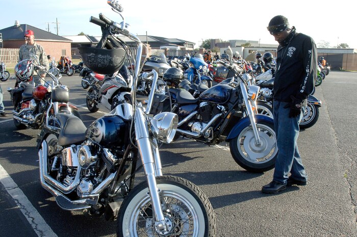 U.S. Navy Master Chief Petty Officer Mike Jackson takes a close look at a motorcycle during an annual mandatory meeting for all Joint Base Charleston motorcycle riders, which kicked off Air Mobility Command?s Spring Safety Focus March 19, 2010 at the base theater. One hundred and thirty-four bikes which included cruisers and sports bikes showed up to participate in a "best in show" contest and the opportunity to participate in a Motorcycle Mentoring ride to Naval Weapons Station Short Stay after the mandatory meeting. Chief Jackson is the NWS Charleston command master chief.  (U.S. Air Force photo/Staff Sgt. Marie Brown)