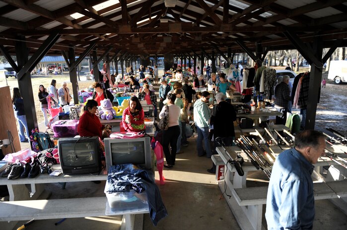 Potential buyers browse the various tables at a base-wide yard sale on Joint Base Charleston, S.C., Mar. 20, 2010. After the base-wide event finished, many donated their unsold items to the Airmen's Attic for Airmen just starting out at the base, rather than being used for a later sale. The event was held to give base members a chance to offer unneeded belongings to others, while making a profit on the side. (U.S. Air Force photo/Senior Airman Jennifer L. Flores)