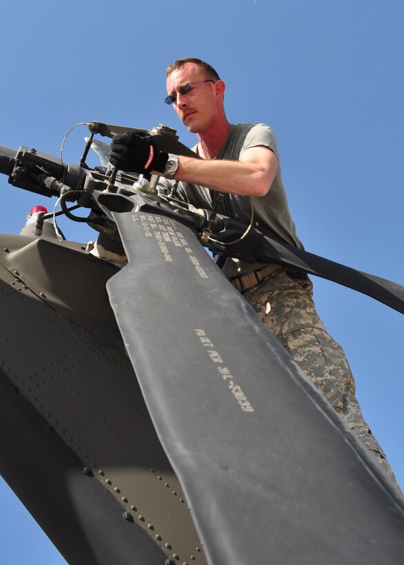 Specialist Ryan Boyer, aircrew member, 1st Battalion, 228th Aviation Regiment, realigns the rear rotor on a UH-60 Blackhawk March 21. The 1-228th deployed in support of Joint Task Force-Haiti from Soto Cano Air Base, Honduras March 21 brining more than 180,000 pounds of equipment, UH-60s and personnel. (U.S. Air Force photo/Staff Sgt. Bryan Franks)