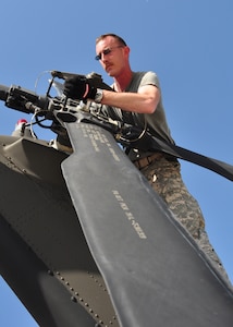 Specialist Ryan Boyer, aircrew member, 1st Battalion, 228th Aviation Regiment, realigns the rear rotor on a UH-60 Blackhawk March 21. The 1-228th deployed in support of Joint Task Force-Haiti from Soto Cano Air Base, Honduras March 21 brining more than 180,000 pounds of equipment, UH-60s and personnel. (U.S. Air Force photo/Staff Sgt. Bryan Franks)