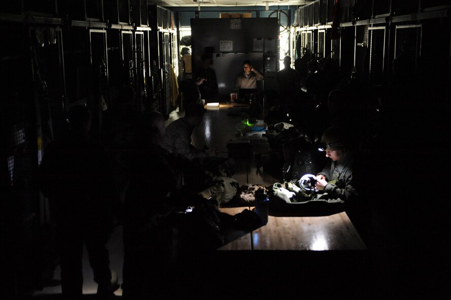 Guardian Angels from the 103rd Rescue Squadron conduct a mobility bag inspection with the use of head mounted flash lights during the blackout. Members of the 106th Rescue Wing carry on with their work on March 15, 2010 after the base power went out during a heavy storm over the weekend at F.S. Gabreski Airport (ANG), N.Y.

(U.S. Air Force Photo/Staff Sgt. David J. Murphy/released)
