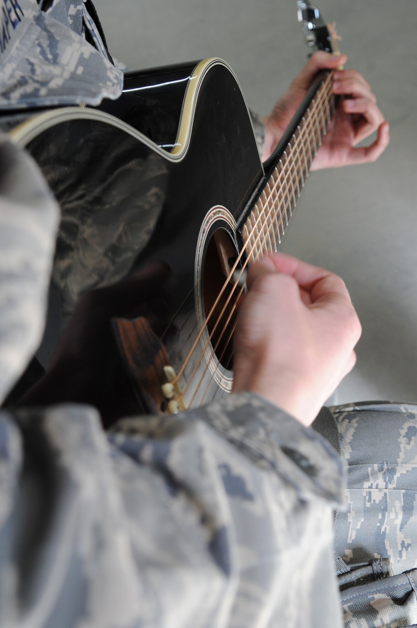 Senior Airman Blake Draper, 506th Air Expeditionary Group Commander's Support Staff, gives a guitar lesson to Tech. Sergeant Russell Dietz, 506 AEG chaplain assistant, on Kirkuk Regional Air Base, Iraq, March 22, 2010. He uses his passion for playing guitar as a positive outlet during his current deployment.  Airman Draper is deployed from Pope AFB, N.C.  (U.S. Air Force photo/Staff Sgt. Tabitha Kuykendall/Released)          
