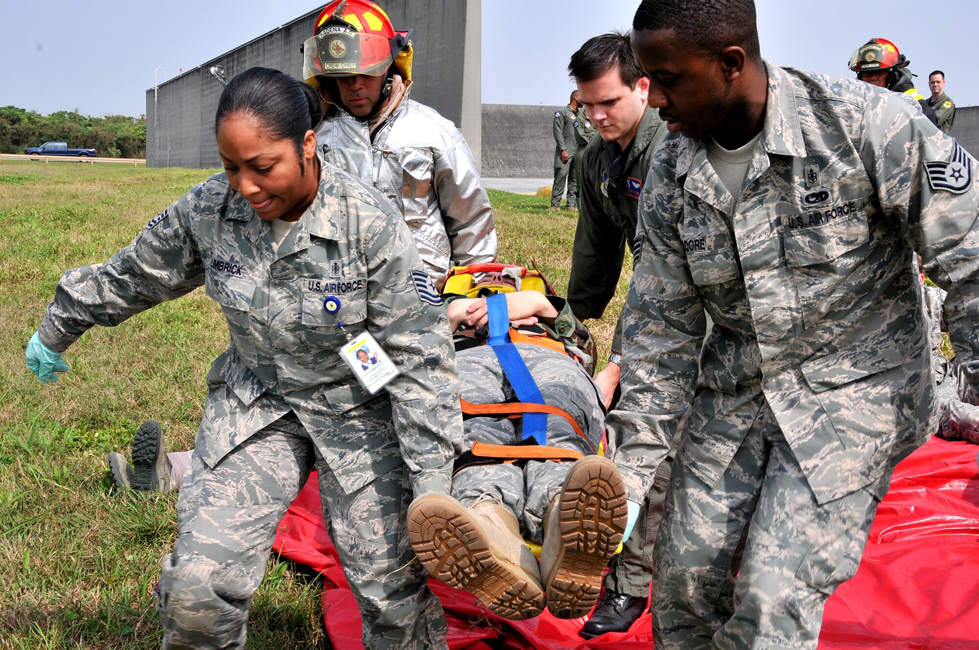 Members from the 18th Medical Group transport a victim for treatment as part of a simulation involving an Airborne Warning and Control System E-3 Sentry engine fire during Beverly High 10-02 at Kadena Air Base, Japan, March 23.  The 18th Wing is participating in a Local Operational Readiness Exercise March 22-26 to test the readiness of Kadena Airmen. (U.S. Air Force photo/Tech. Sgt. Angelique Perez)        