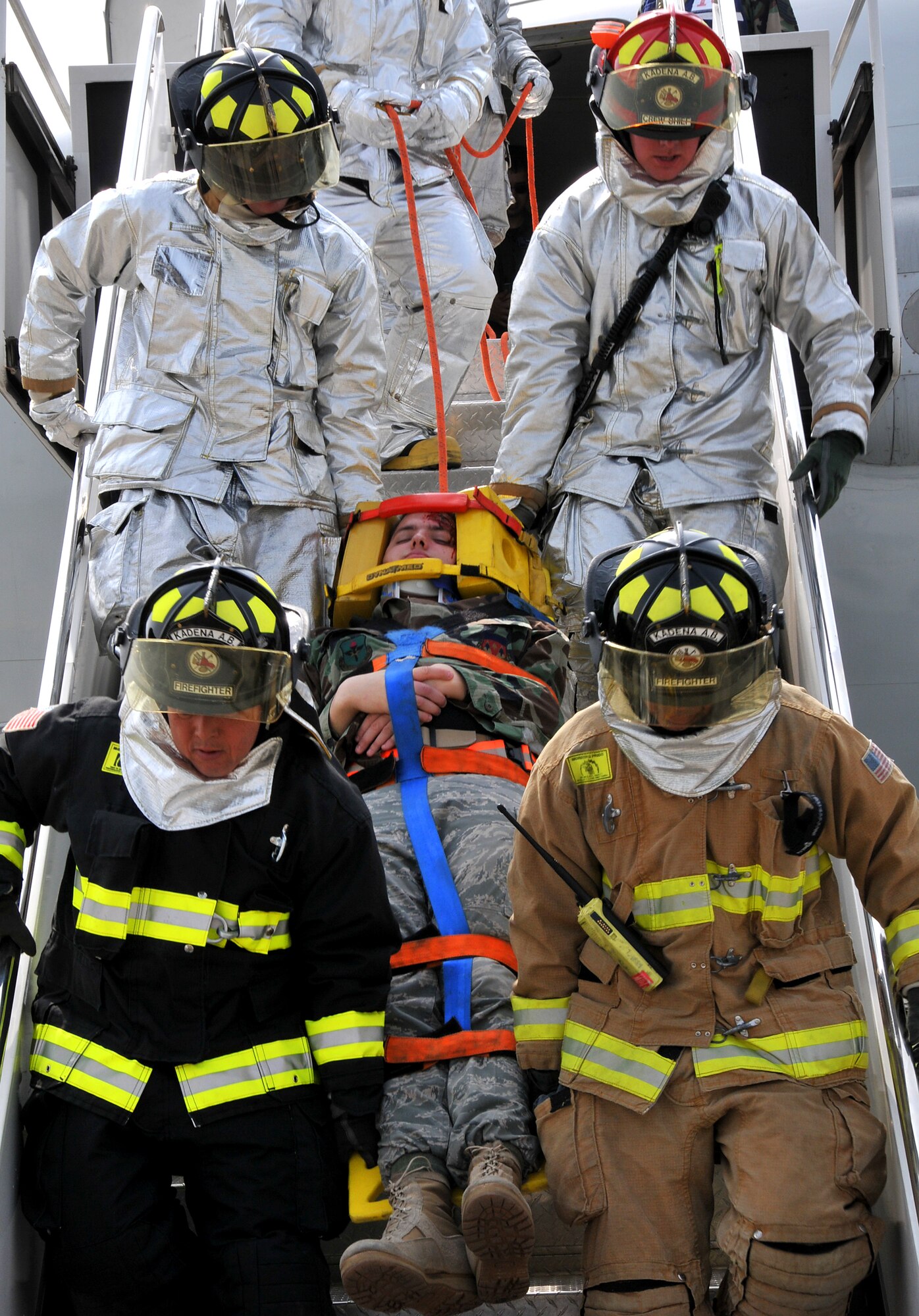 The Kadena Fire Department extract an injured victim in a simulation involving an Airborne Warning and Control System E-3 Sentry engine fire during Beverly High 10-02 at Kadena Air Base, Japan, March 23.  The 18th Wing is participating in a Local Operational Readiness Exercise March 22-26 to test the readiness of Kadena Airmen. (U.S. Air Force photo/Tech. Sgt. Angelique Perez)    