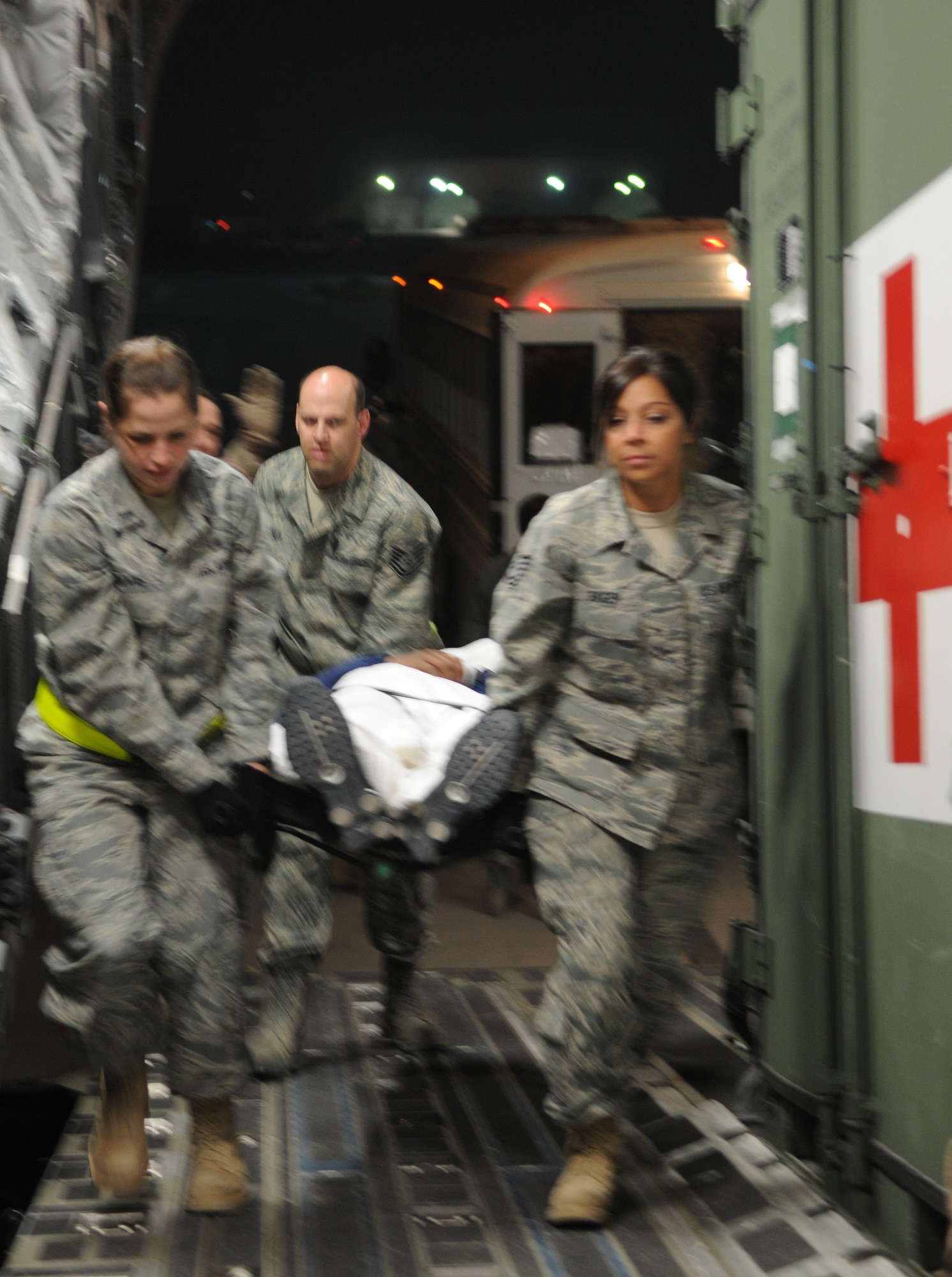 Contingency Aeromedical Staging Facility staff and volunteers load litter patients aboard a C-17 aeromedical evacuation flight to Germany, March 17, 2010. (U.S. Air Force photo by Senior Master Sgt. Stefan Alford/Released)