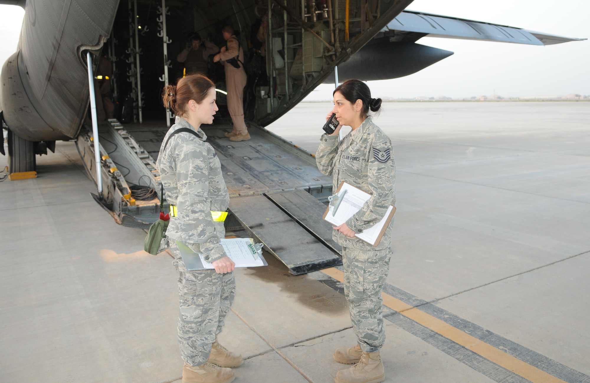 From left, 1st Lt. Janine Banas, Contingency Aeromedical Staging Facility nurse, and Tech. Sgt. Katherine Eagen, CASF medical technician, coordinate patient movement details for a C-130 mission within theater. (U.S. Air Force photo by Senior Master Sgt. Stefan Alford/Released)