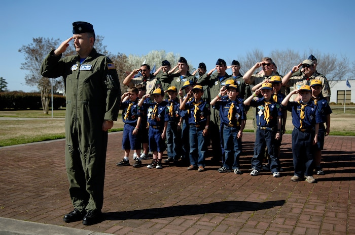 Lt. Col. Richard Williamson salutes in formation alongside Cub Scouts at a retreat ceremony March 19, 2010, at Joint Base Charleston, S.C. Eleven Cub Scouts were given the opportunity to witness the precision of a live military retreat performed by members of the 17th Airlift Squadron. Colonel Williamson is the commander of the 17 AS. (U.S. Air Force photo/Senior Airman Timothy Taylor)
