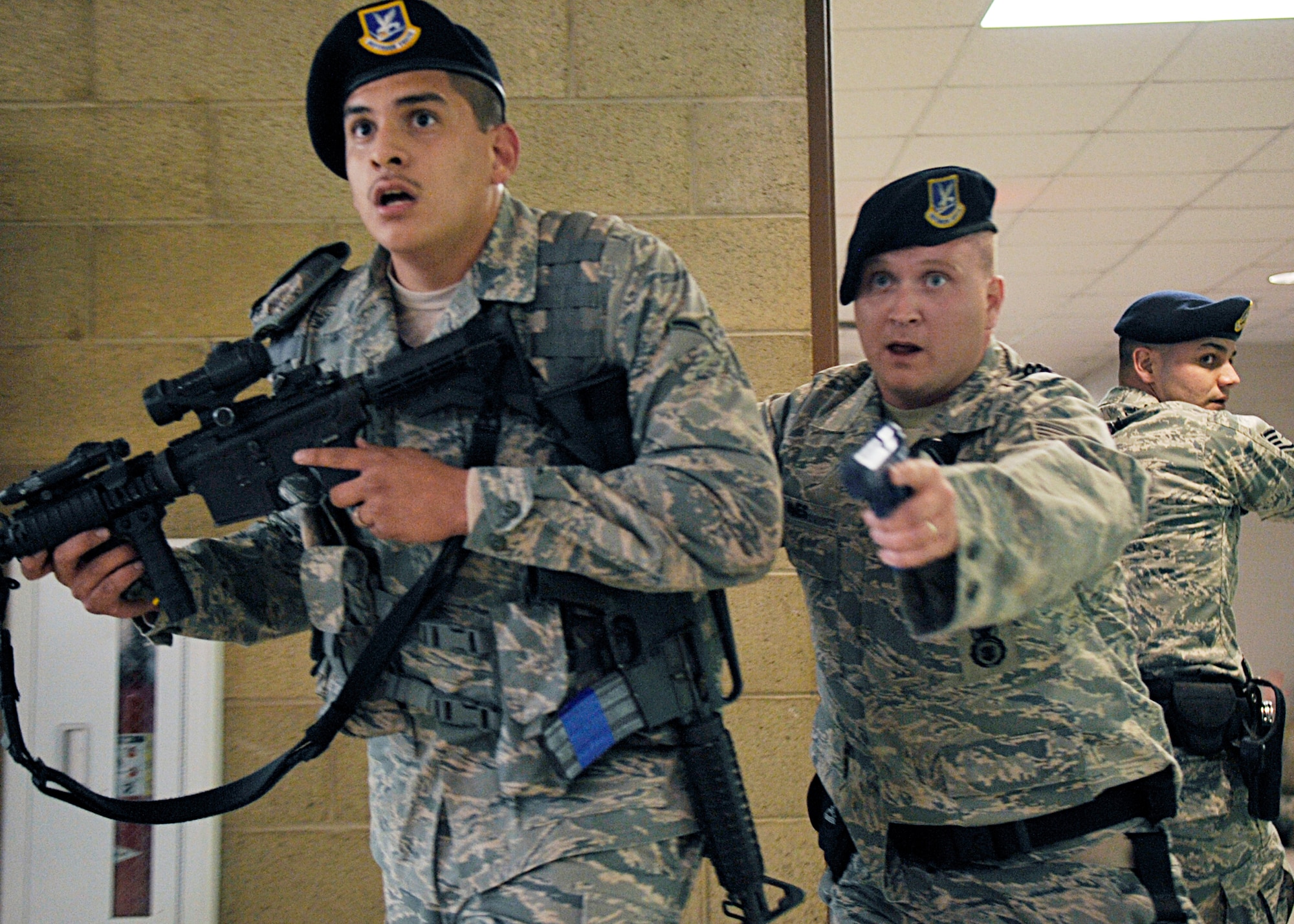 Airman Pedro Escobar, Staff Sgt. Craig Ames and Staff Sgt. Michael Morris conduct a building sweep at the Domenici Fitness and Sports Center March 11, 2010, at Holloman Air Force Base, N.M. The active shooter exercise helped prepare the 49th Fighter Wing members for future exercises and possible real-world situations. Airman Escobar and Sergeants Ames and Morris are 49th Security Forces Squadron members. (U.S. Air Force photo/Staff Sgt. Anthony Nelson Jr.)