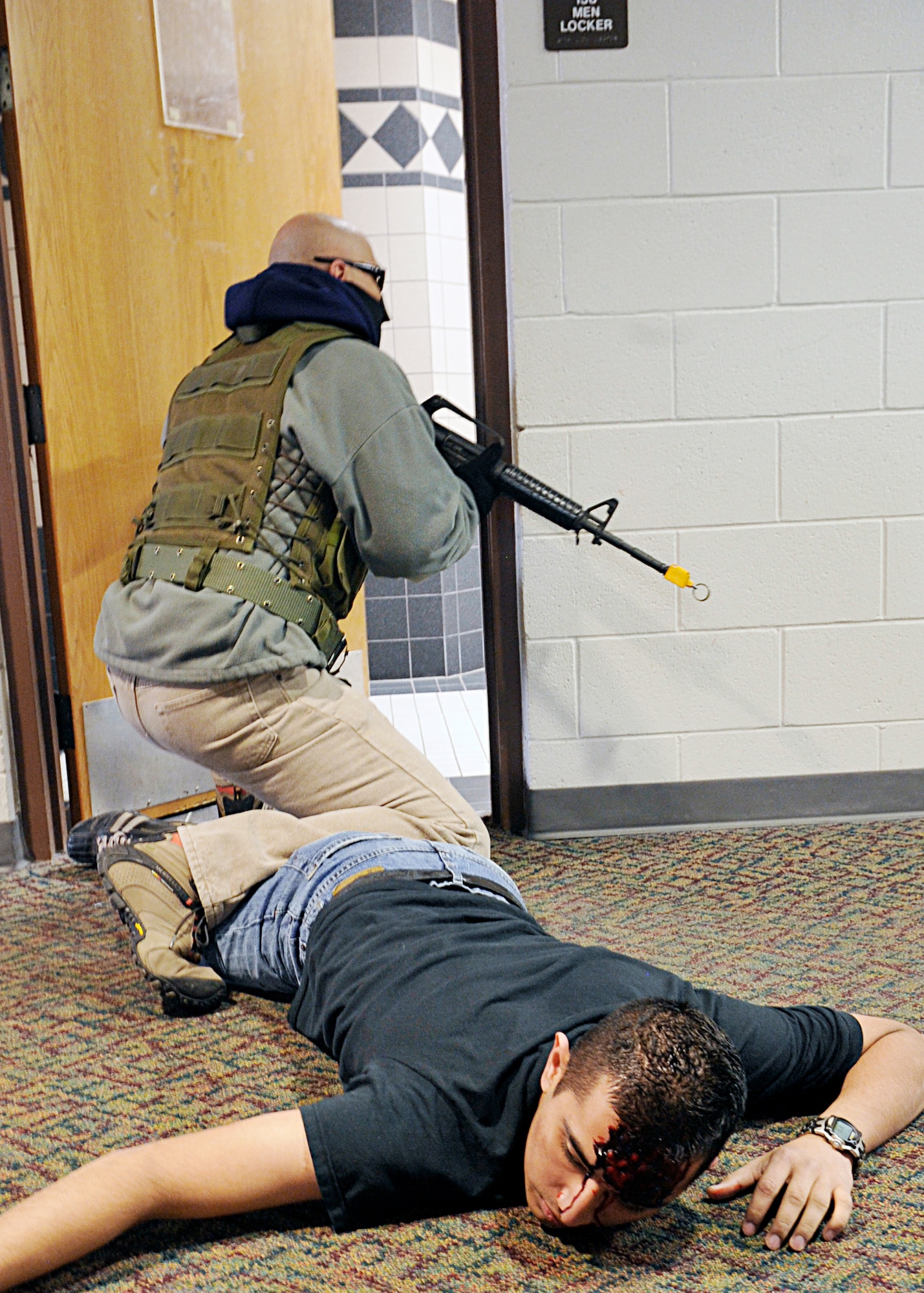 A security forces Airmen looks for an armed gunman as a simulated individual lays on the ground after being injured by the gunmen during an exercise March 11, 2010, at Holloman Air Force Base, N.M. (U.S. Air Force photo/Staff Sgt. Anthony Nelson Jr.)
