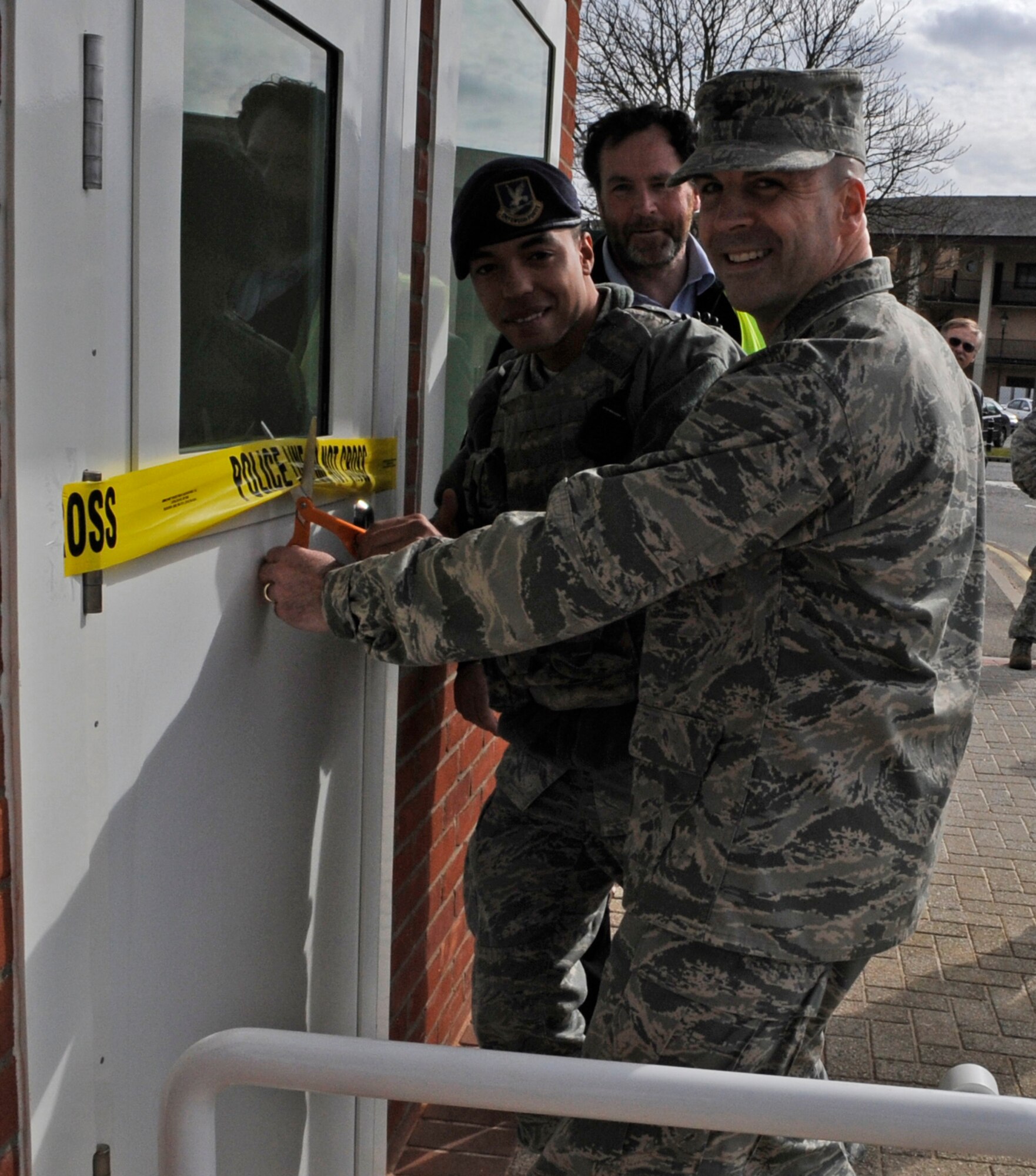 RAF MILDENHALL, England – Col. Chad Manske, 100th Air Refueling Wing commander, cuts the ribbon for the new hardened guard shelter March 22.  The facility started construction in July of 2009. (U.S. Air Force photo/Staff Sgt. Christopher L. Ingersoll)