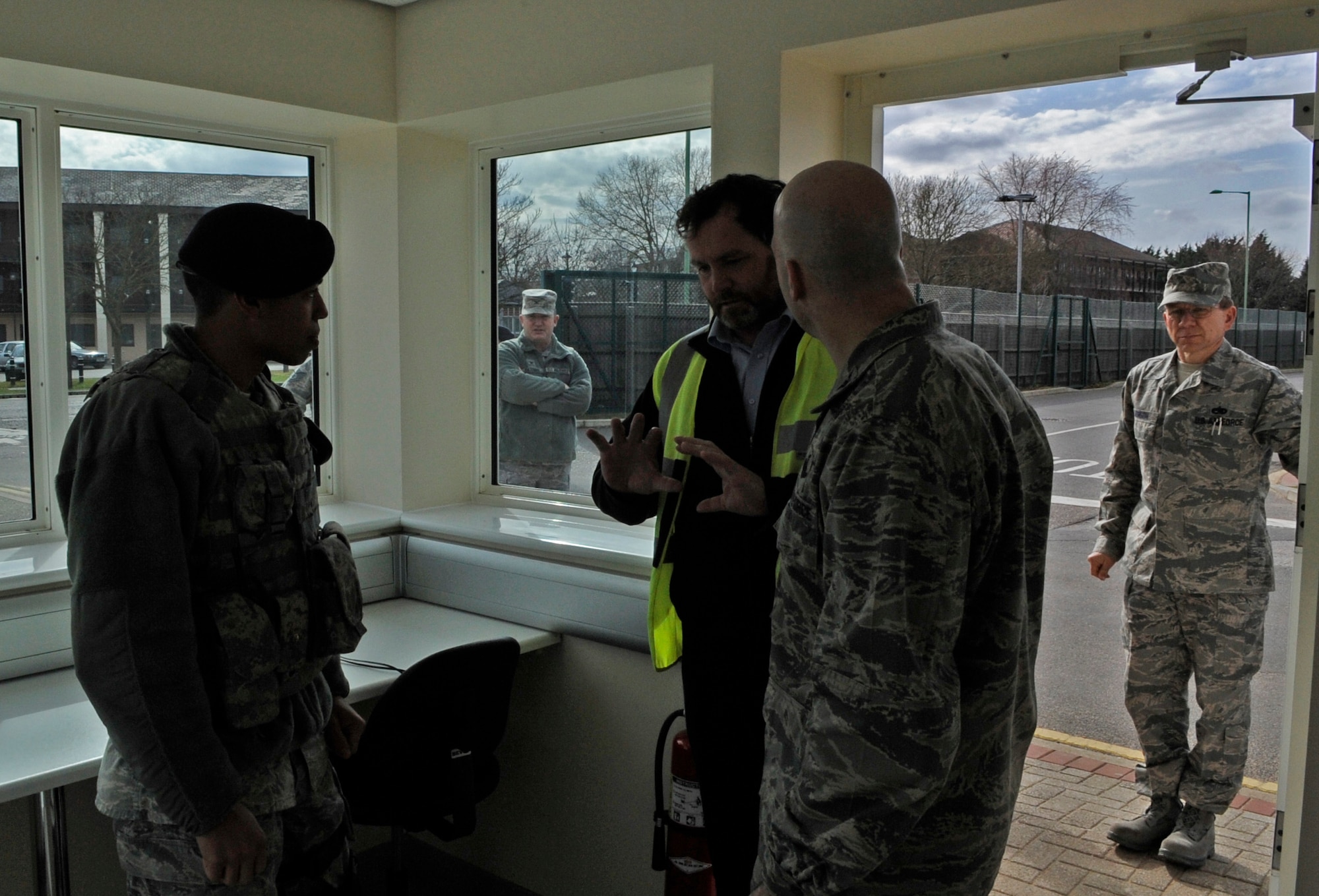 RAF MILDENHALL, England – Col. Chad Manske, 100th Air Refueling Wing commander, Airman 1st Class Alex Torres, 100th Security Forces Squadron, and Chris Nicholson, 100th Civil Engineer Squadron project manager, open a new guard shelter March 22.  (U.S. Air Force photo/Staff Sgt. Christopher L. Ingersoll)