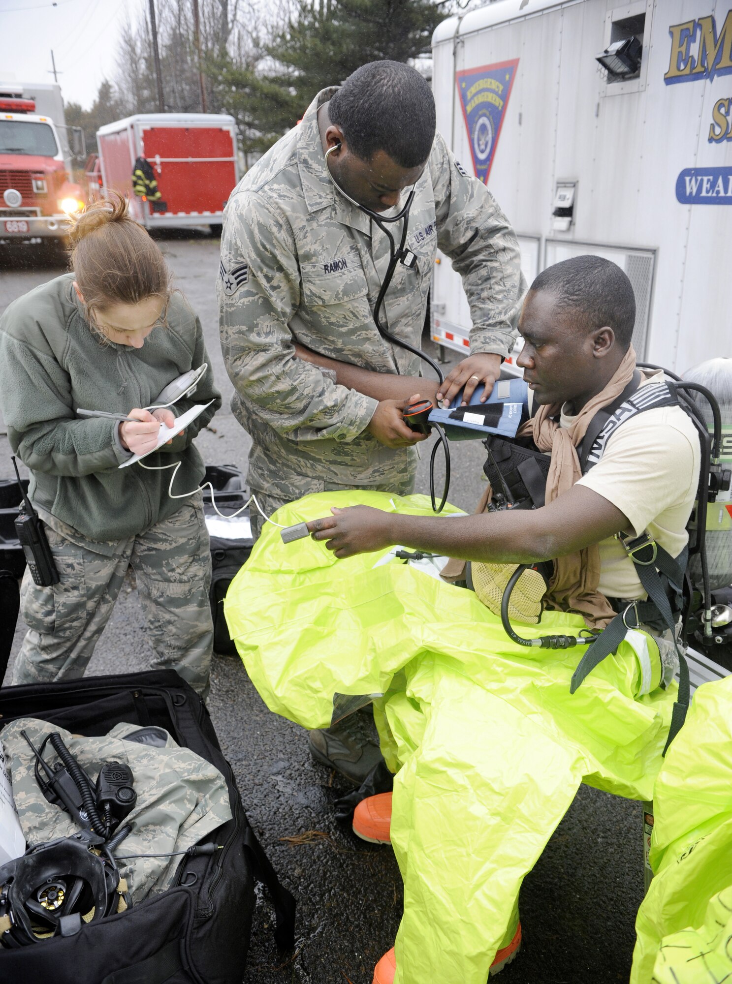 Members of the 87th Medical Group check the vital signs of all the members of the HAZMAT Team following the decontamination process during a HAZMAT Crisis Exercise March 15 . The HAZMAT Exercise is used as a tool to gauge the strengths and weaknesses of the first responders, and how well they work together to complete the mission. (U.S. Air Force photo/Carlos Cintron)
