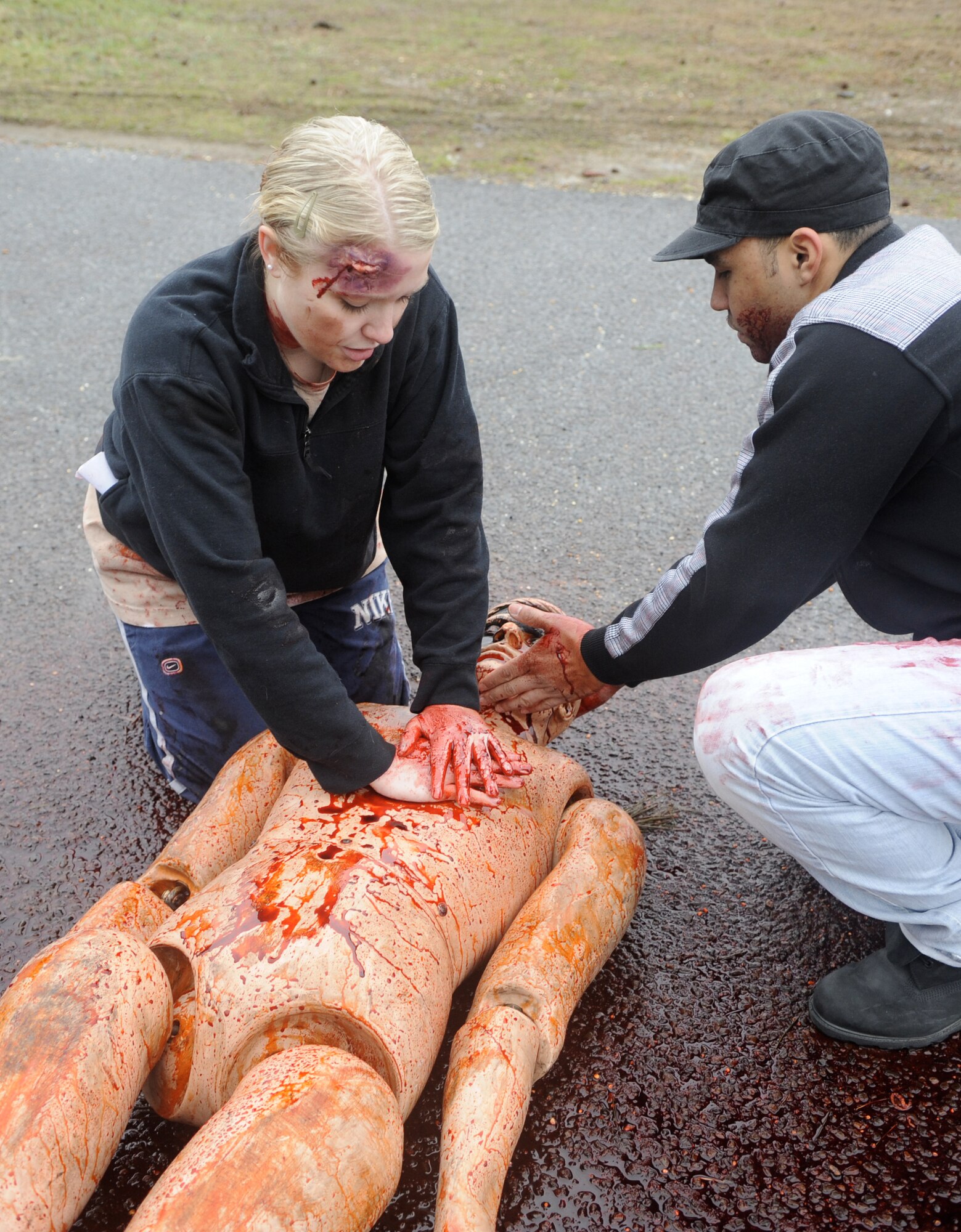 Simulated vehicle accident victims perform CPR on a mannequin in a staged treatment area during a HAZMAT crisis exercise here March 15.  Personnel from multiple units on Joint Base McGuire-Dix-Lakehurst participated in the exercise to improve effective communication and coordination. (U.S. Air Force photo/Carlos Cintron)
