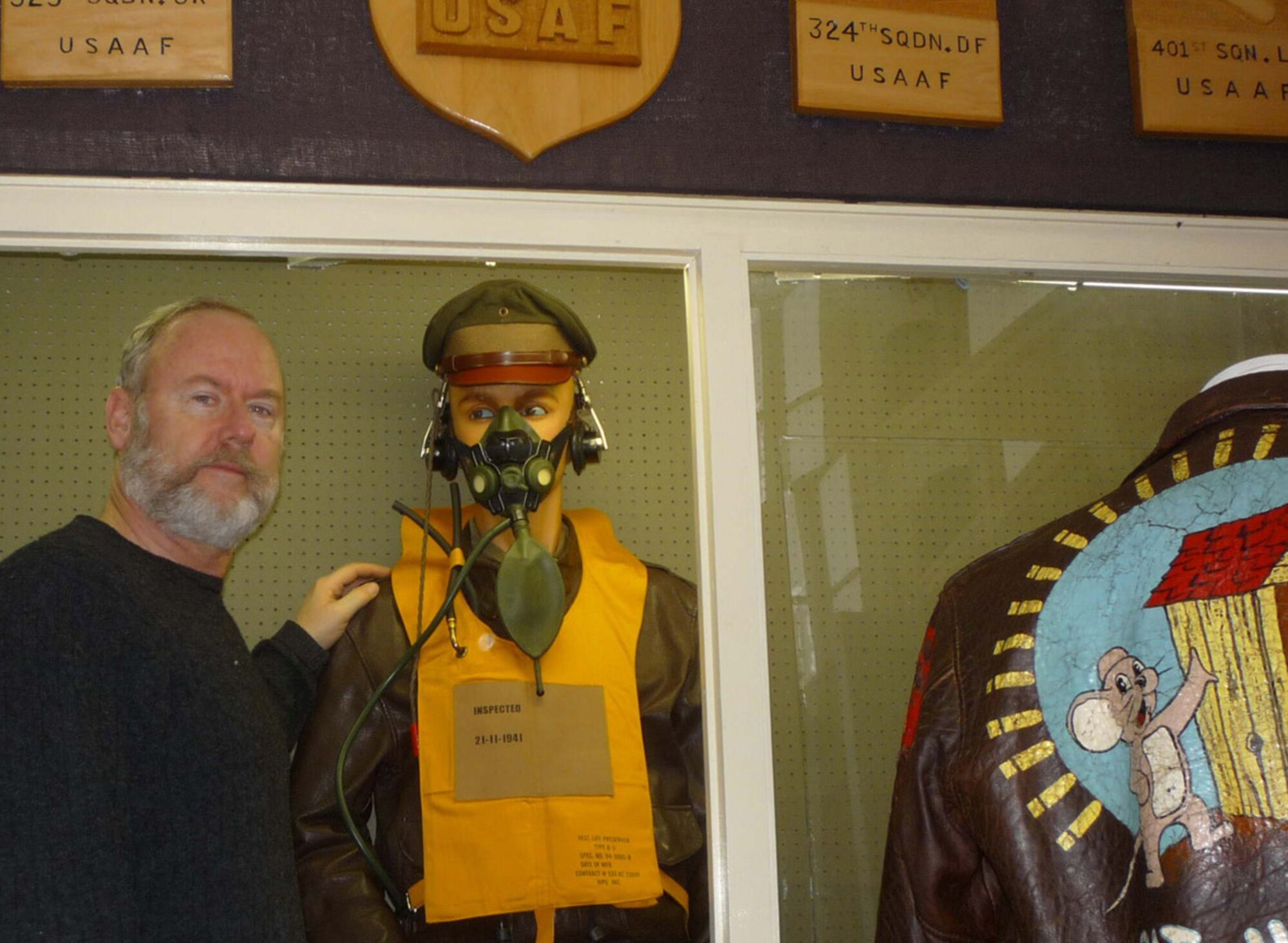 Bassingbourn Museum volunteer and 3rd Air Force International Relations Chief, Tom Gill, stands in front of the uniform of the Capt. Bob Morgan display. Captain Morgan commanded the Memphis Belle aircraft through 25 combat missions over Europe in 1943. (Courtesy photo)