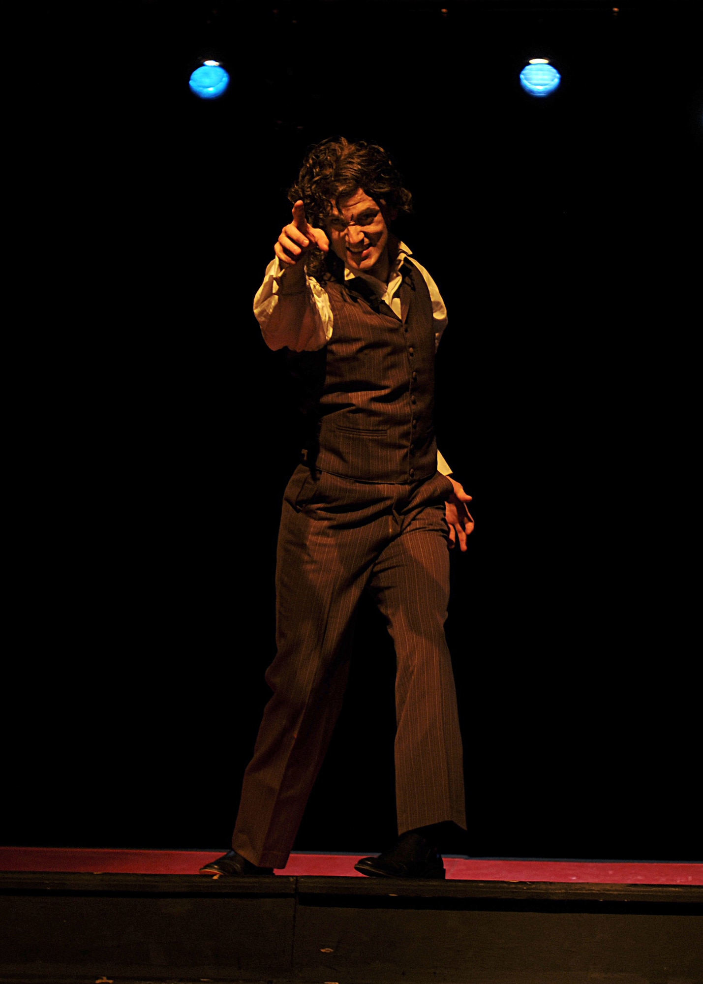 Staff Sgt. David Wade Weaver, 31st Comptroller Squadron travel pay NCOIC, plays the title characters in "Jekyll and Hyde: The Musical," March 19 at the Aviano High School multipurpose room.  The next performances will be March 25 to 27, starting at 8 p.m. Tickets are sold at the door and are $5 for E-4 and below or equivalent and $10 for anyone else.  (U.S. Air Force photo/Senior Airman Tabitha M. Mans)