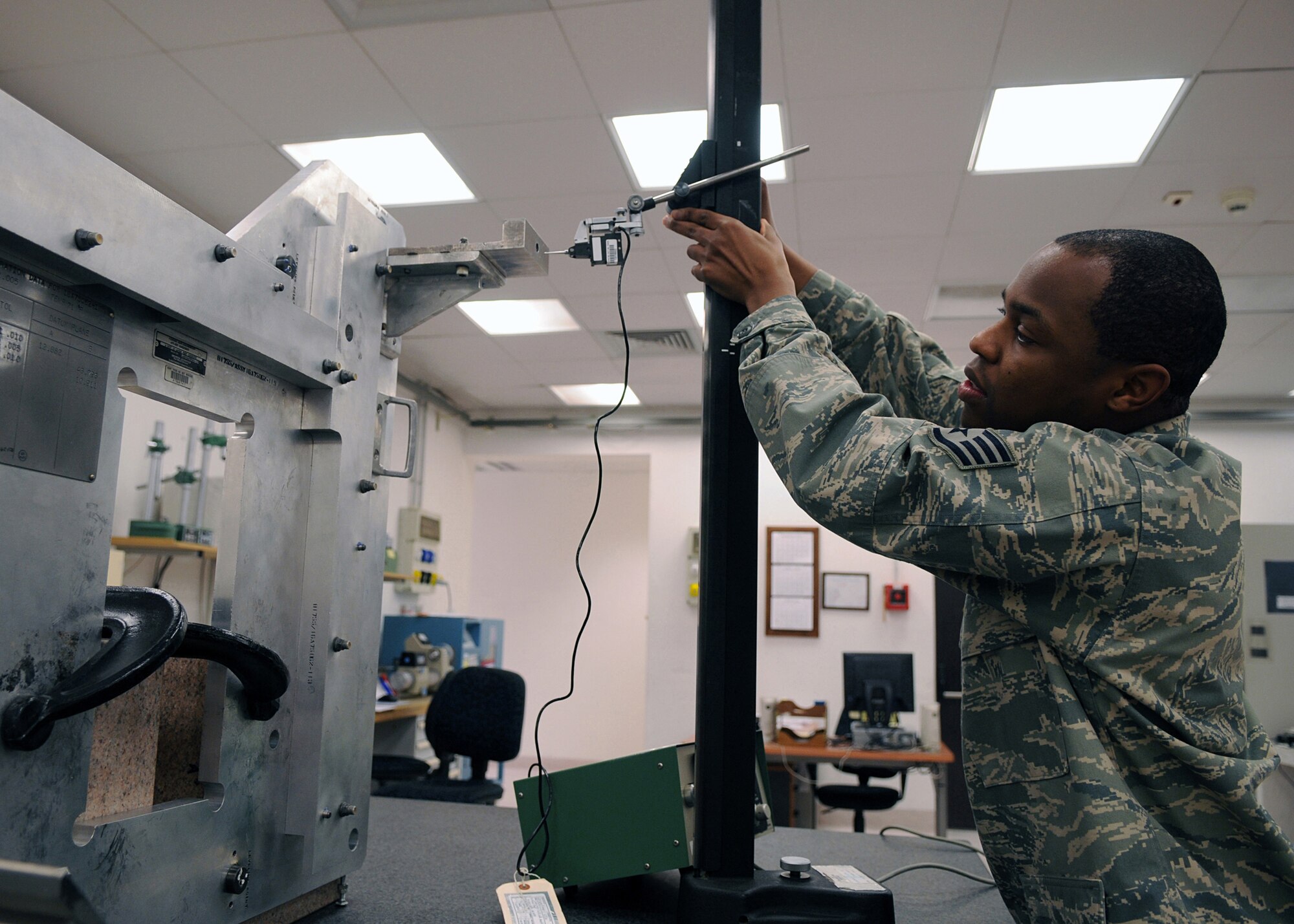 Staff Sgt. Gerald Johnson, 31st Maintenance Squadron, a test, measurement and diagnostic equipment technician uses an electronic height guage to calibrate a metal fixture of an F-16 Fighter Falcon.Precision Measurement Equipment Laboratory troops support more than 5,950 different types of equipment such as spectrum analyzers, torque wrenches, and pressure gauges, by thoroughly fine-tuning them to meet the four criteria of accuracy, reliability, traceability and safety. (U.S. Air Force photo/Senior Airman Taylor L. Marr)
