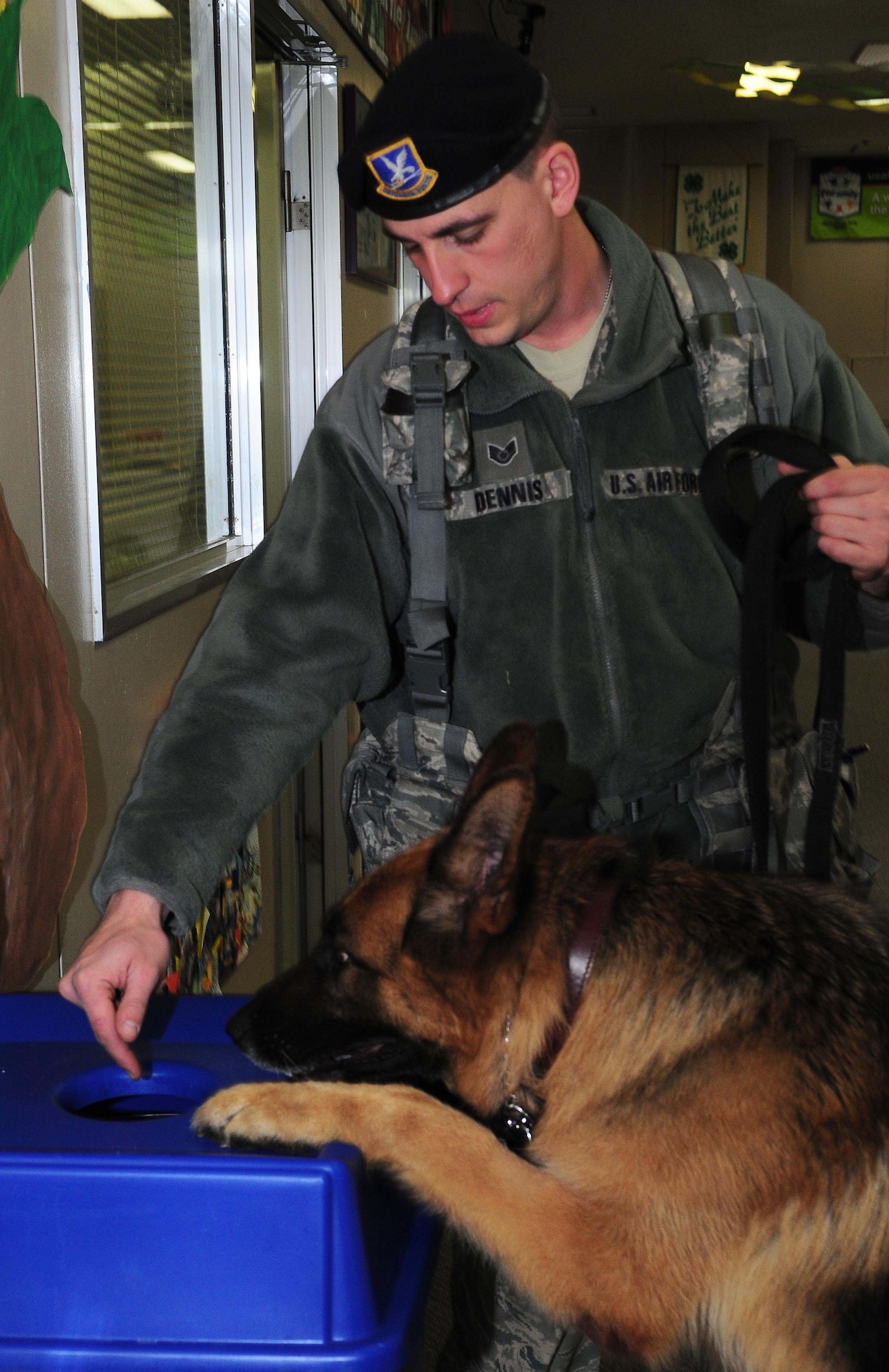 YOKOTA AIR BASE, Japan -- Staff Sgt. Arthur Dennis, 374th Security Forces Squadron K-9 handler, motions for working dog Fedor to search a recycle bin for drugs during proficiency training March 23. SFS working dogs are routinely trained to perfect the skills essential to their mission. (U.S. Air Force photo/Airman 1st Class Lynsie Lorenz)