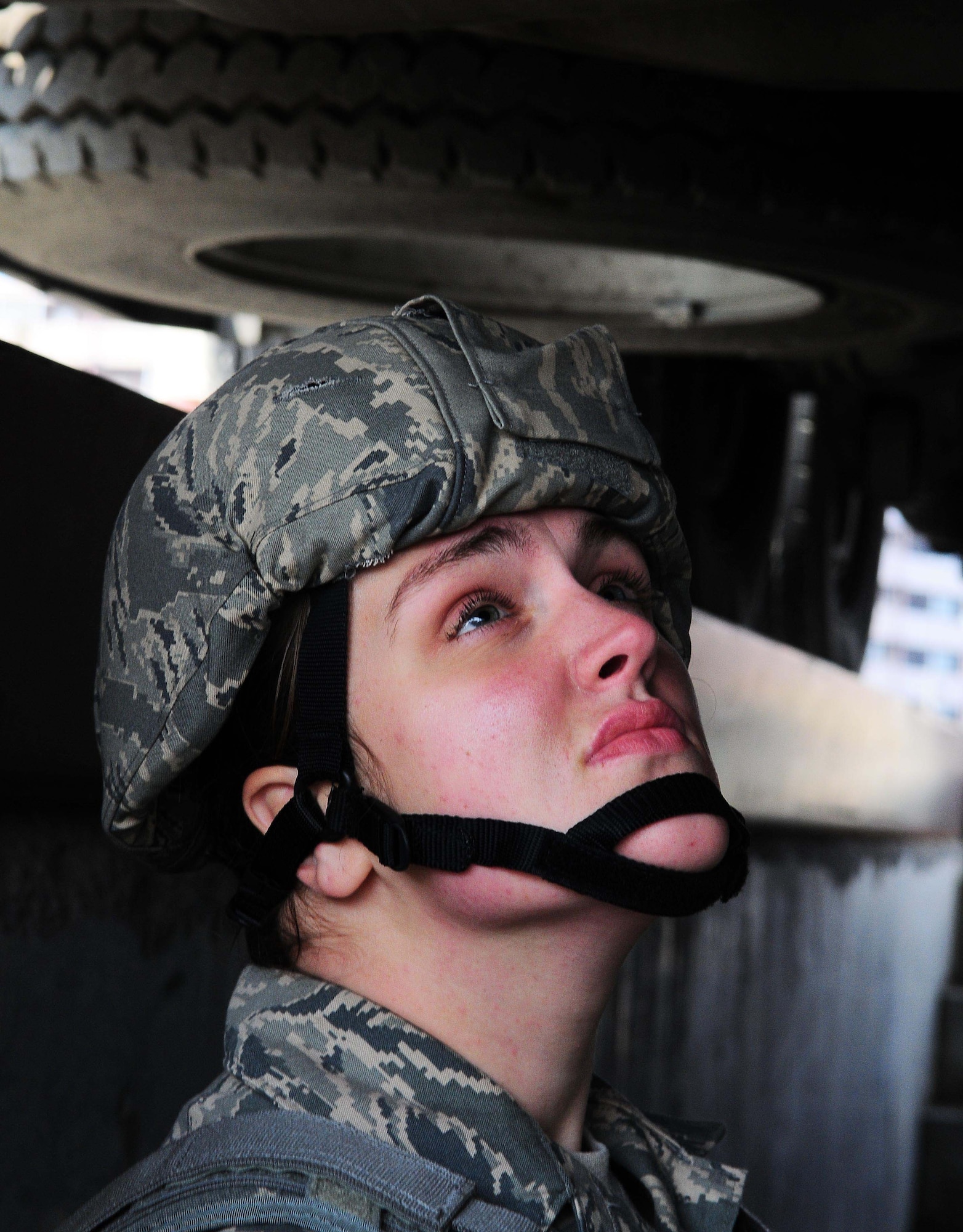 YOKOTA AIR BASE, Japan -- Airman 1st Class Melissa Burazin, 374th Security Forces Squadron Patrolman, checks under a cargo vehicle during a routine security check. Security Forces Airmen conduct routine checks on cargo vehicles for suspicious materials. (U.S. Air Force photo/Airman 1st Class Lynsie Lorenz)

