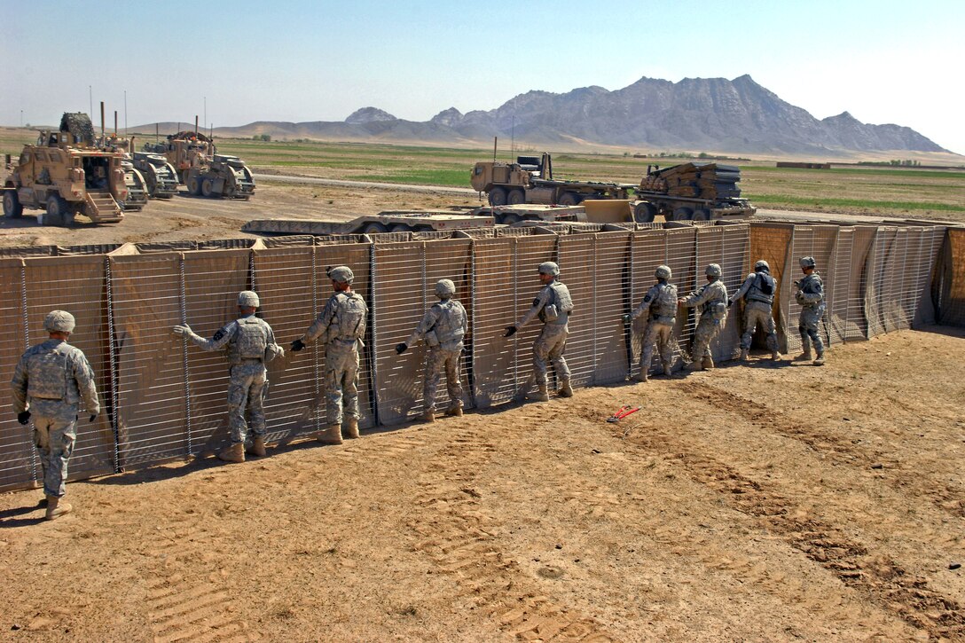 U.S. Army soldiers construct an Afghan police checkpoint in Robat, Afghanistan, March 19, 2010. The soldiers are assigned to the 2nd Infantry Division's 5th Stryker Brigade Combat Team.