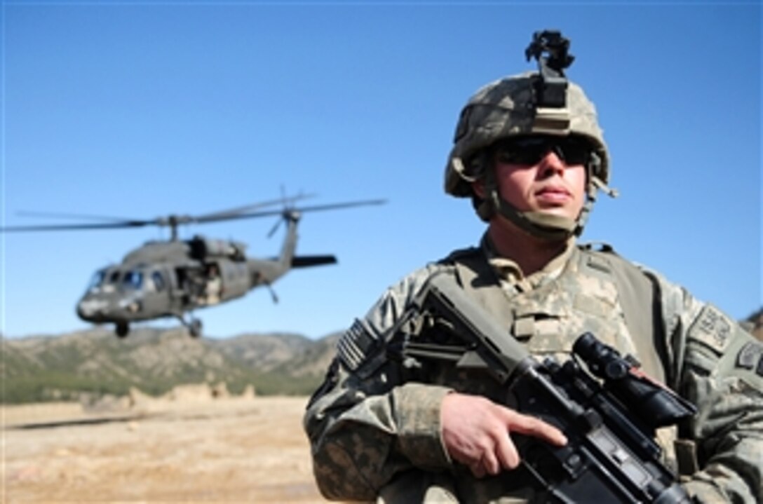 U.S. Army Pfc. Cory Obitts, of Alpha Troop, 1st Squadron, 33rd Cavalry Regiment, provides security for a UH-60 Black Hawk helicopter at Combat Outpost Spera in Khost province, Afghanistan, on March 7, 2010.  