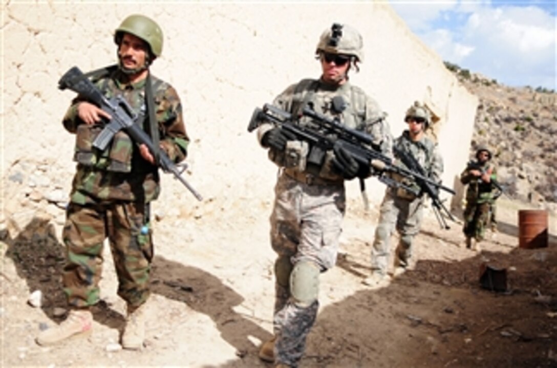 U.S. Army Sgt. William Corcoran, with Alpha Troop, 1st Squadron, 33rd Cavalry Regiment, leads a patrol with Afghan National Army soldiers through Spera in Khost province, Afghanistan, on March 12, 2010.  