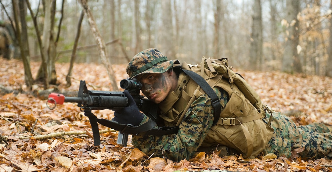 Lance Cpl. Ethan Leasman provides cover while his squad "buddy rushes" towards mock enemies during field training at Marine Corps Base Quantico, Va., Mar. 24.